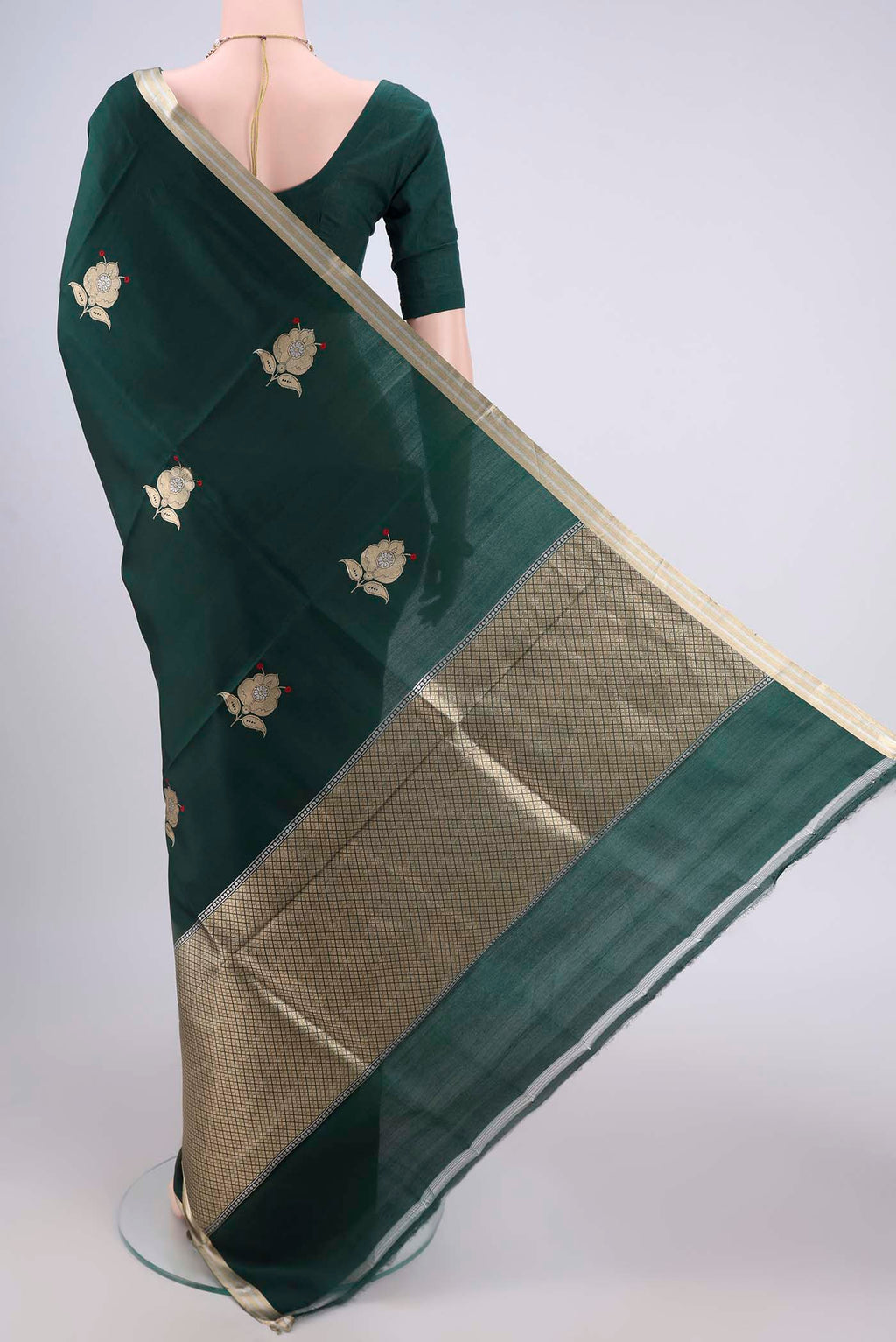 Flat view of Bottle Green Banarasi Katan Silk Saree with Zari Butta on the body and Zari Border. 