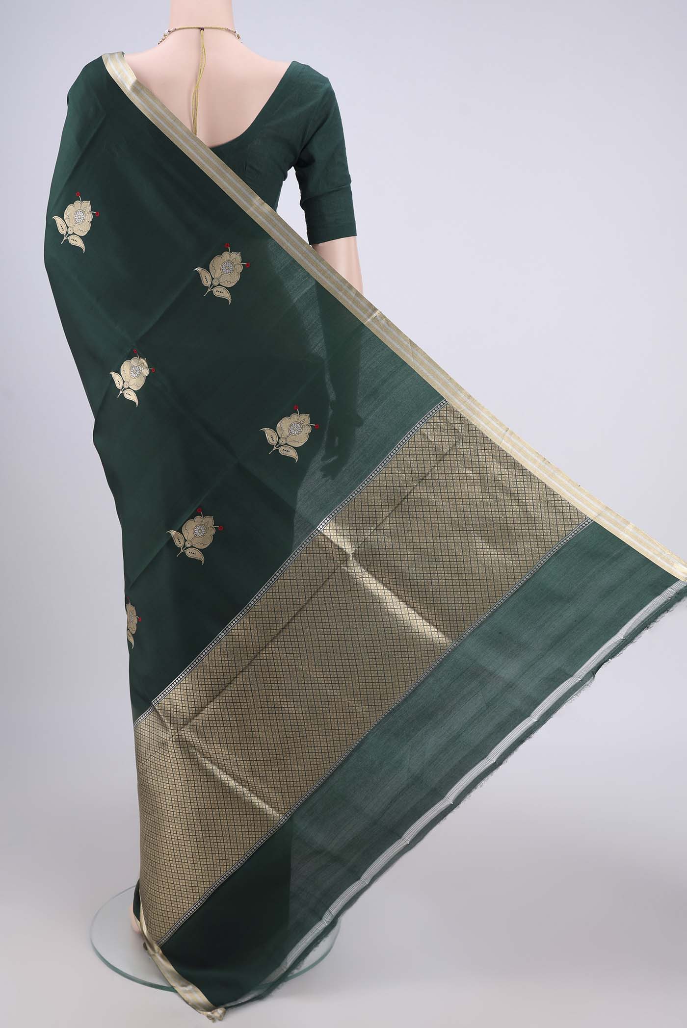 Flat view of Bottle Green Banarasi Katan Silk Saree with Zari Butta on the body and Zari Border. 