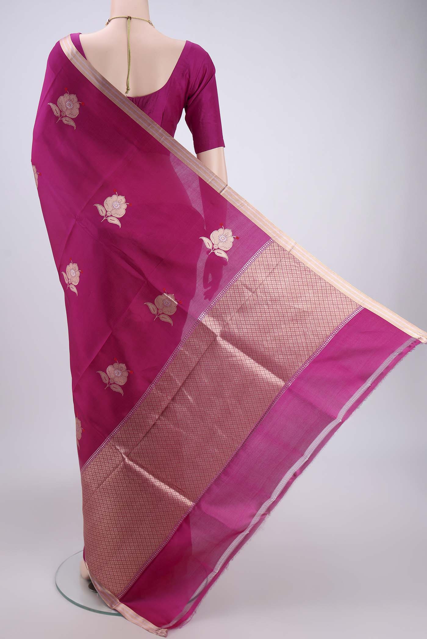 Flat view of Rani Pink Banarasi Katan Silk Saree with Zari And Thread Butta on the body and Zari Border. 