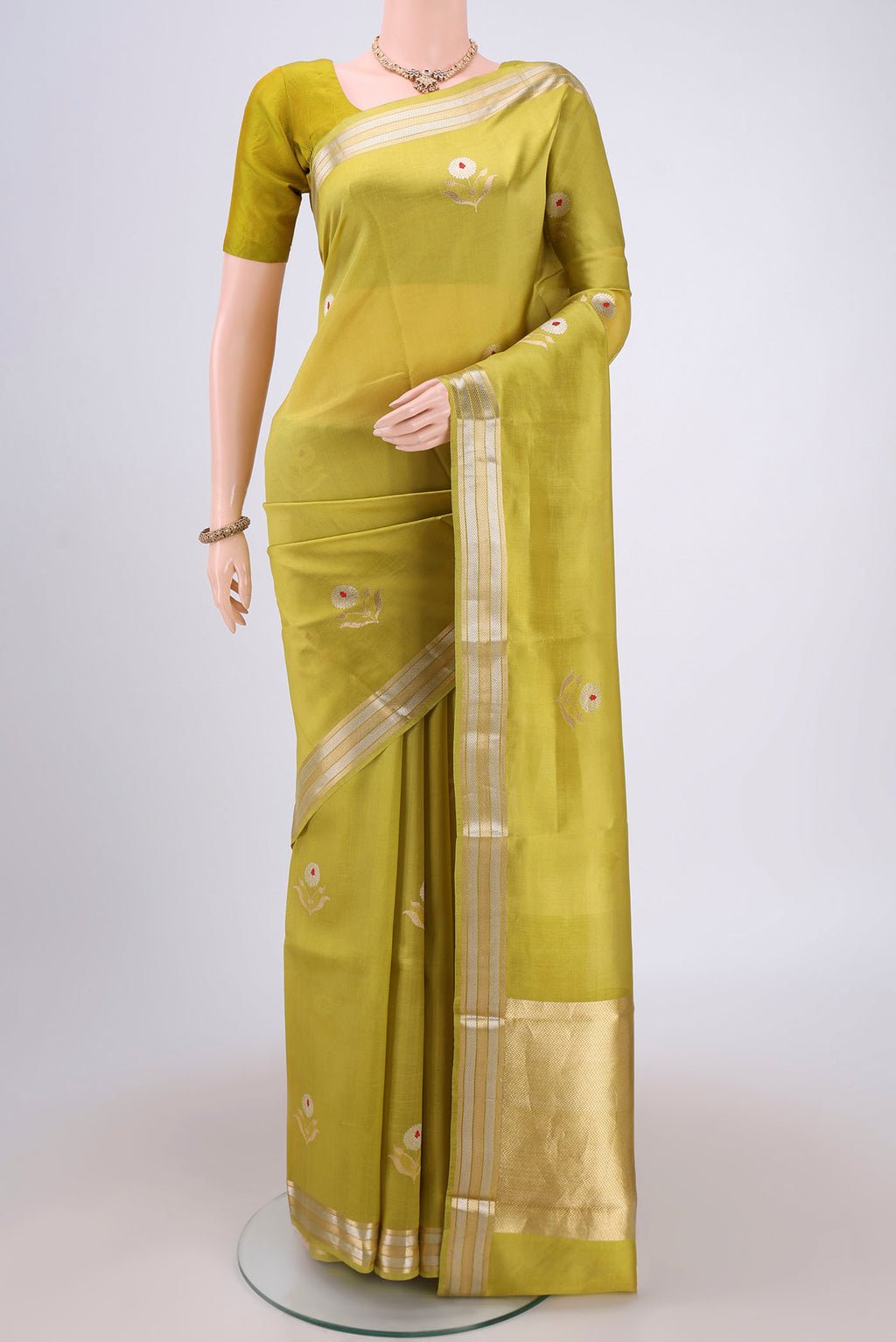 Light Green Banarasi Katan Silk Saree with Zari And Thread Butta on the body and Zari Border.  displayed on a mannequin