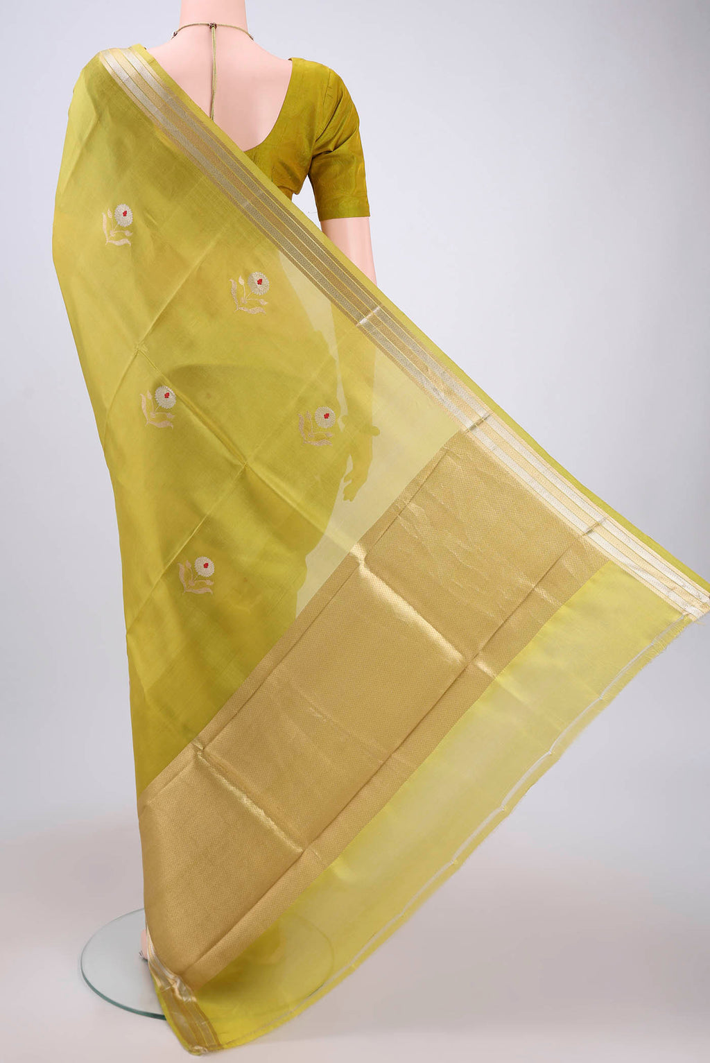 Flat view of Light Green Banarasi Katan Silk Saree with Zari And Thread Butta on the body and Zari Border. 