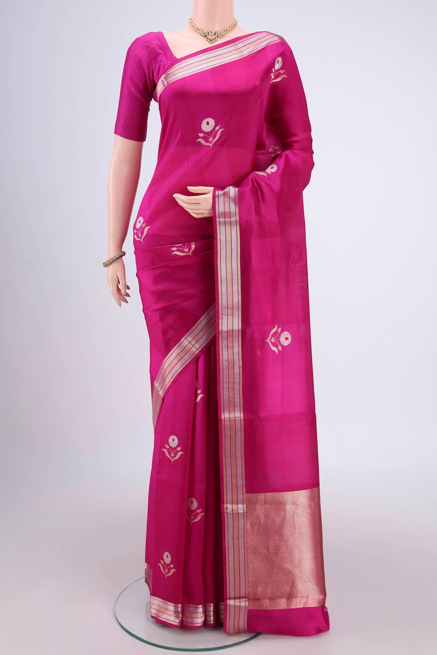 Rani Pink Banarasi Katan Silk Saree with Zari And Thread Butta on the body and Zari Border.  displayed on a mannequin