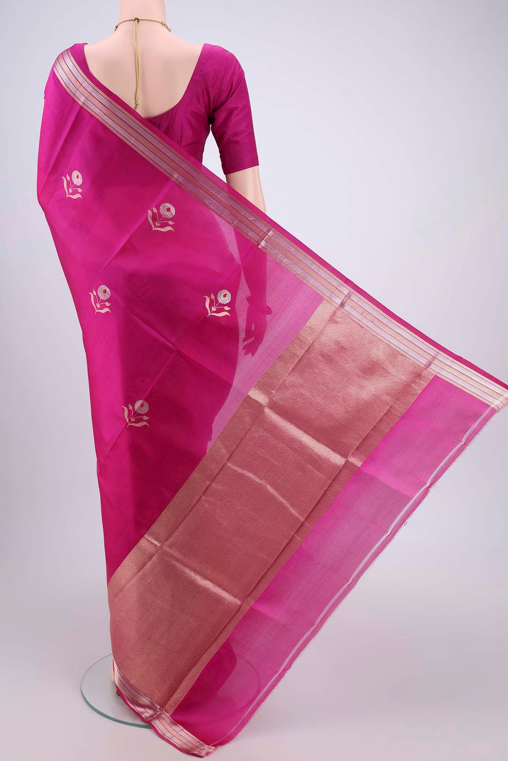 Flat view of Rani Pink Banarasi Katan Silk Saree with Zari And Thread Butta on the body and Zari Border. 