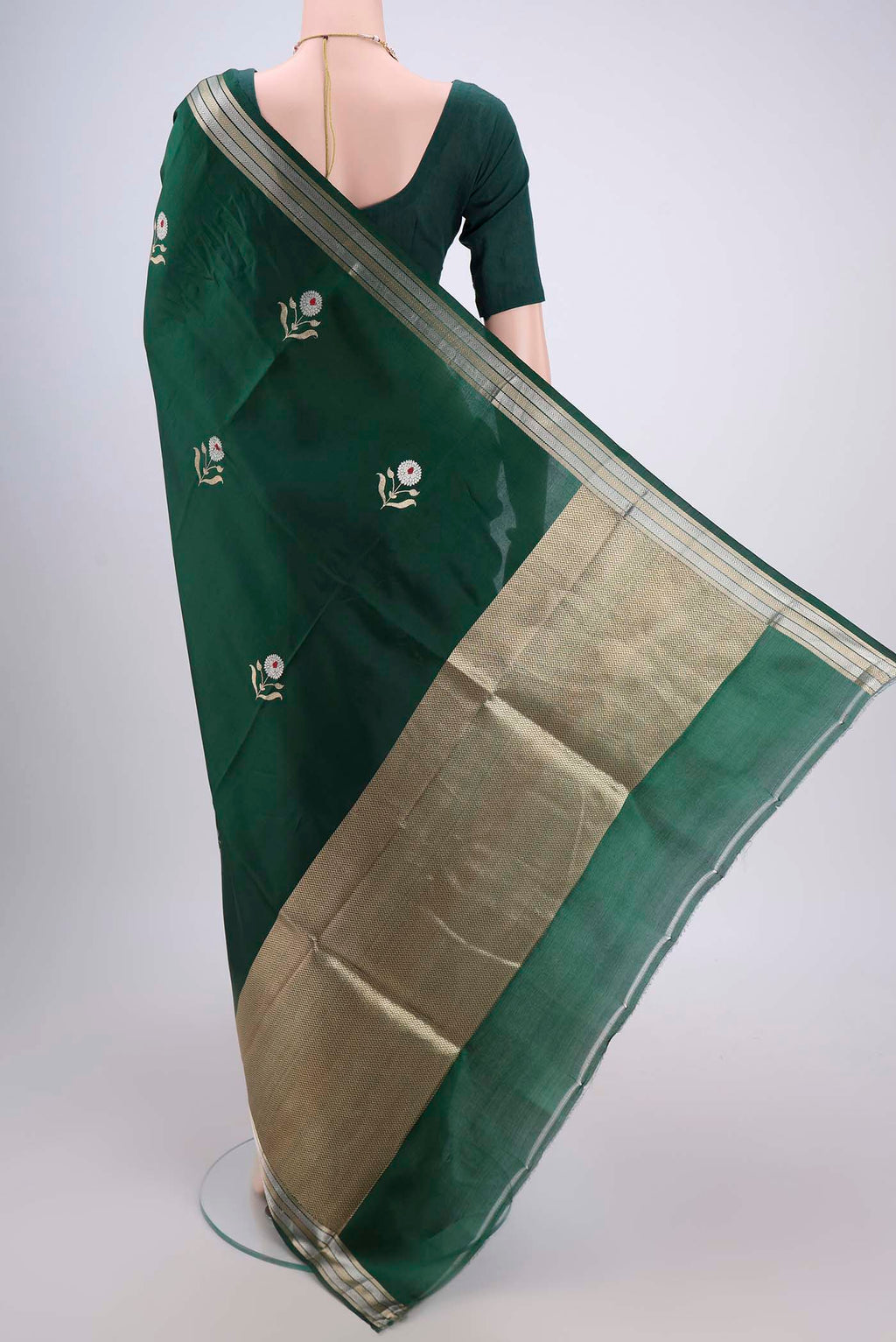 Flat view of Bottle Green Banarasi Katan Silk Saree with Zari And Thread Butta on the body and Zari Border. 