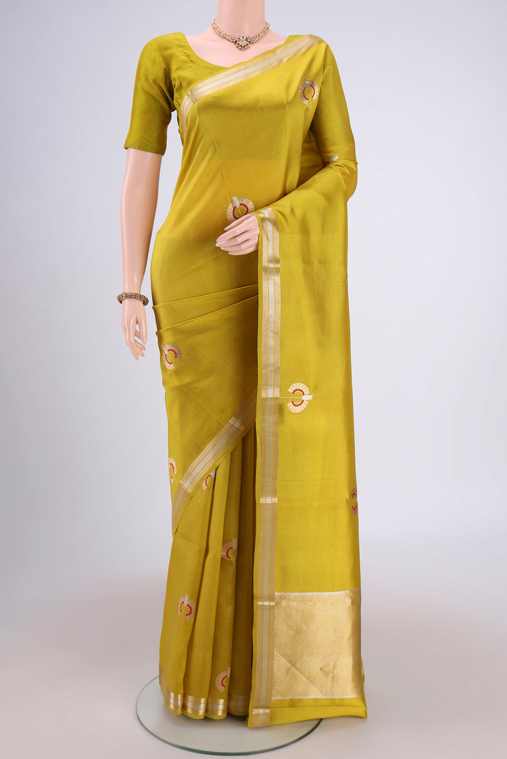 Light Green Banarasi Katan Silk Saree with Zari Butta on the body and Zari Border.  displayed on a mannequin