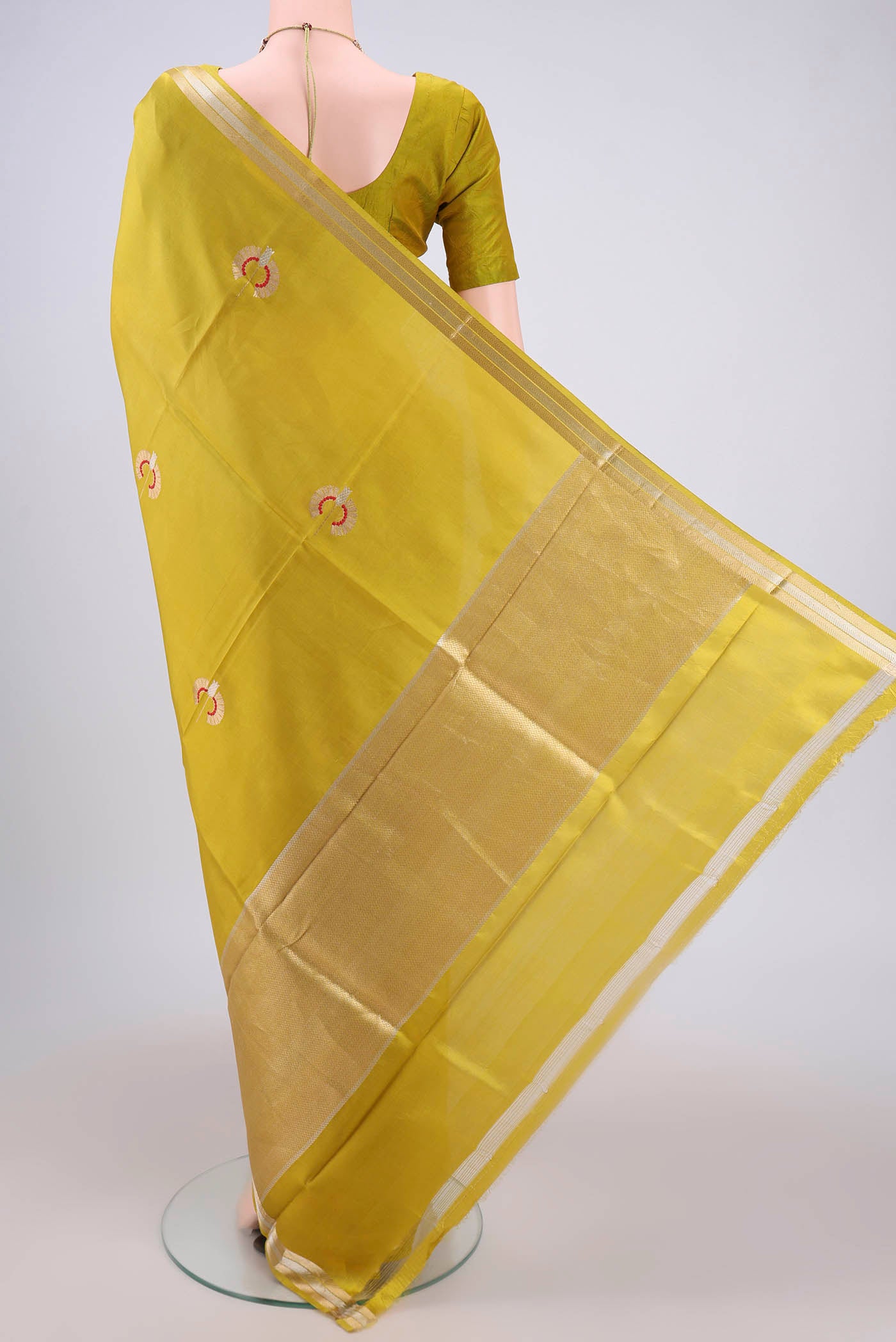Flat view of Light Green Banarasi Katan Silk Saree with Zari Butta on the body and Zari Border. 