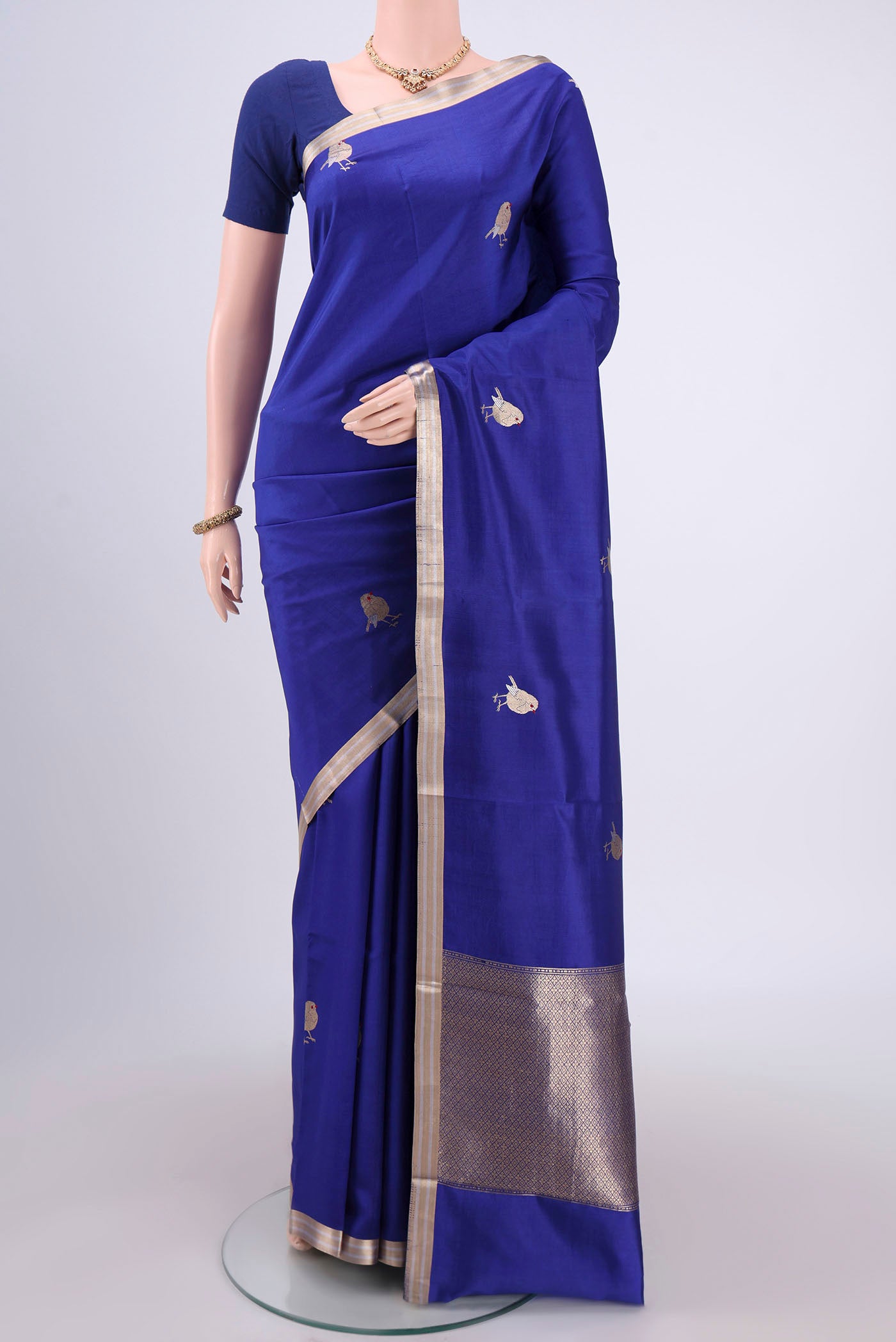 Royal Blue Banarasi Katan Silk Saree with Zari Butta on the body and Zari Border.  displayed on a mannequin