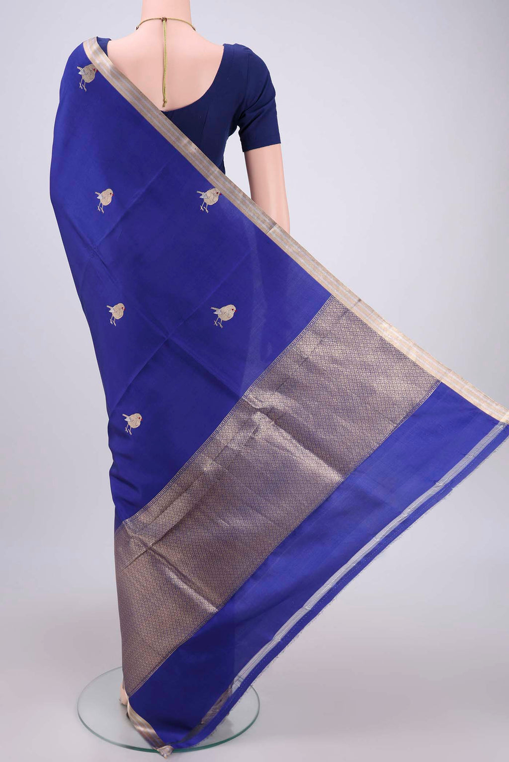 Flat view of Royal Blue Banarasi Katan Silk Saree with Zari Butta on the body and Zari Border. 