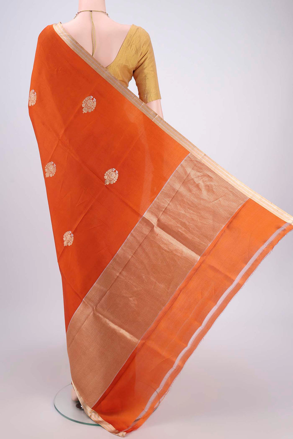 Flat view of Rust Banarasi Katan Silk Saree with Zari Butta on the body and Zari Border. 