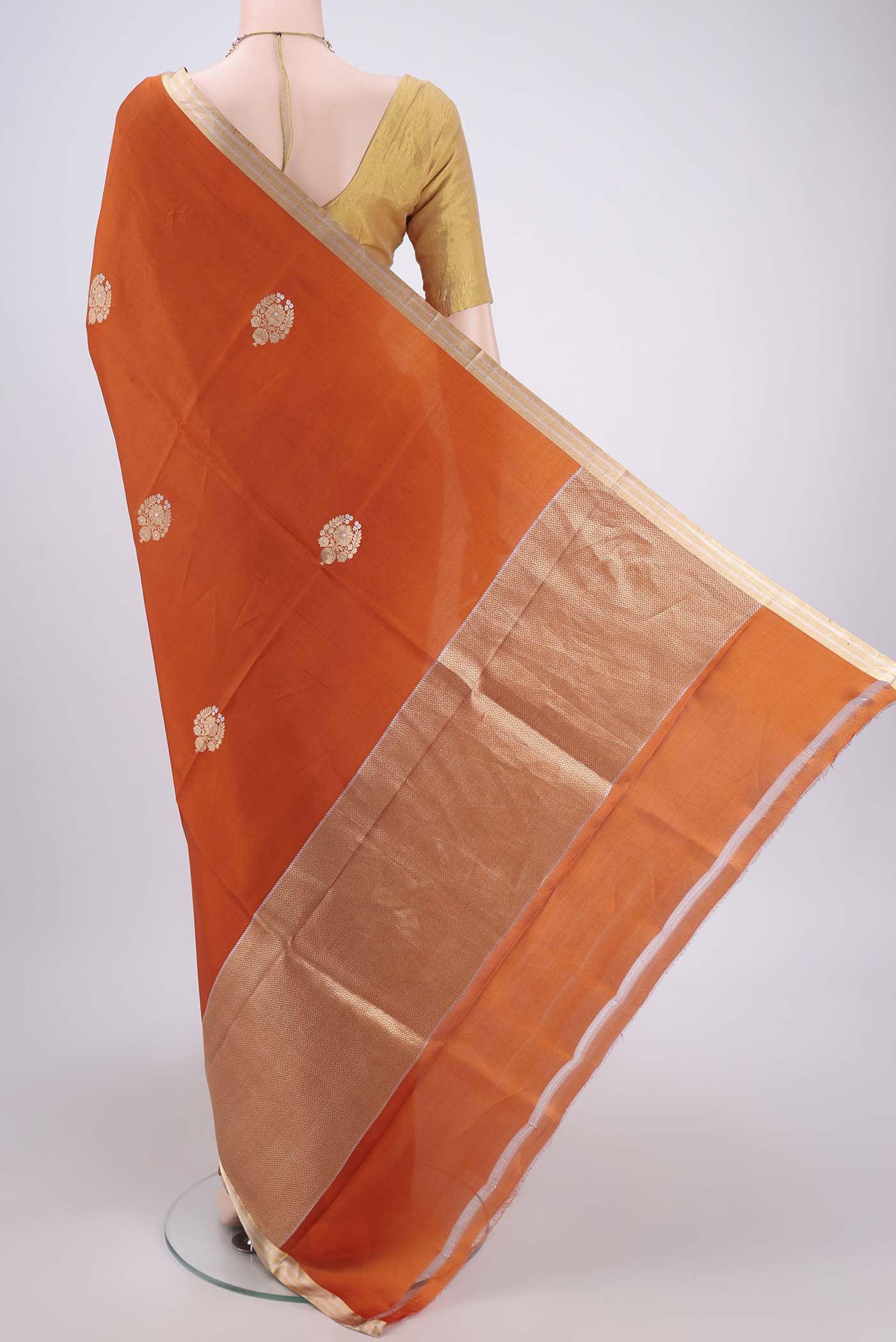 Flat view of Rust Banarasi Katan Silk Saree with Zari Butta on the body and Zari Border. 