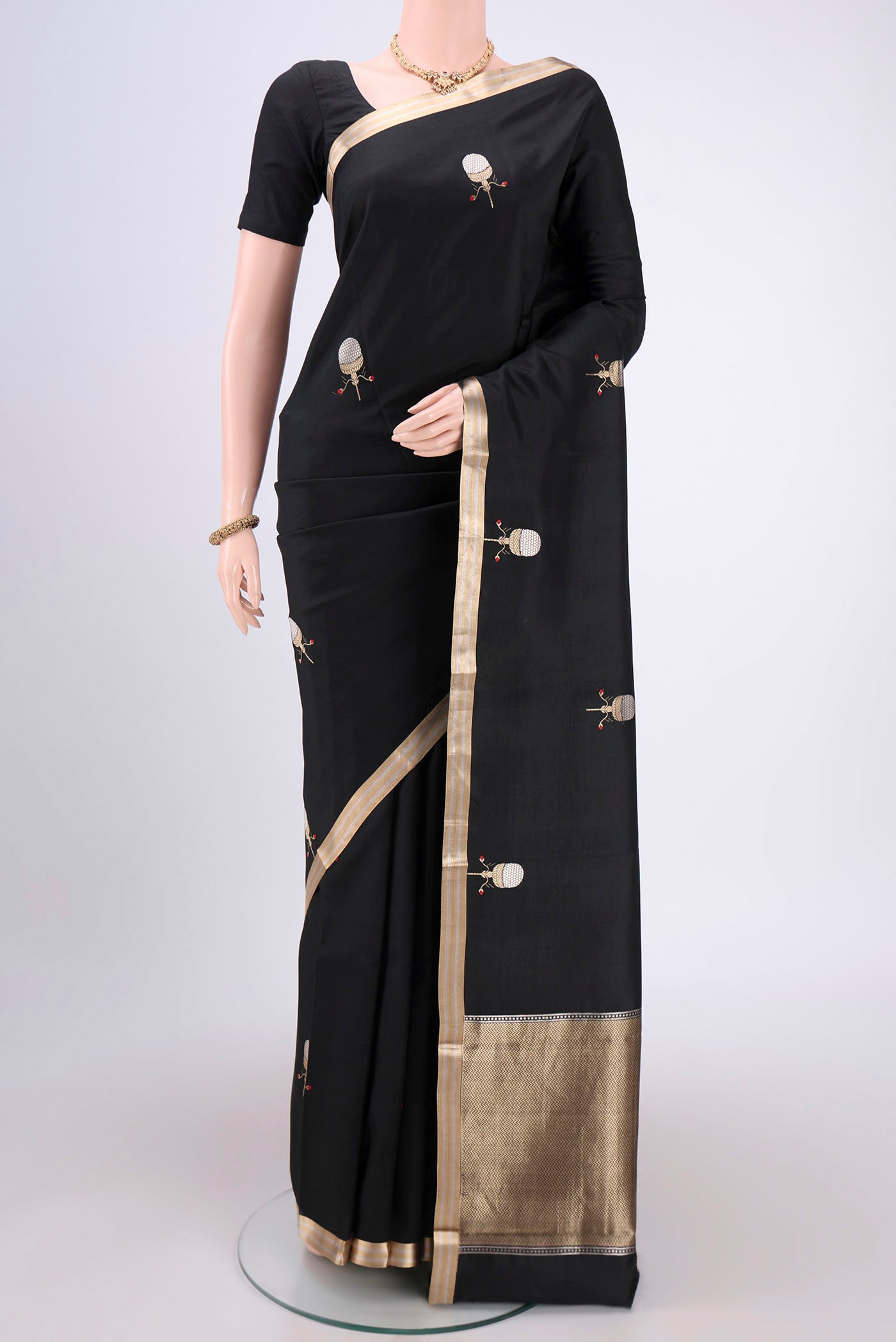Black Banarasi Katan Silk Saree with Zari Butta on the body and Zari Border.  displayed on a mannequin
