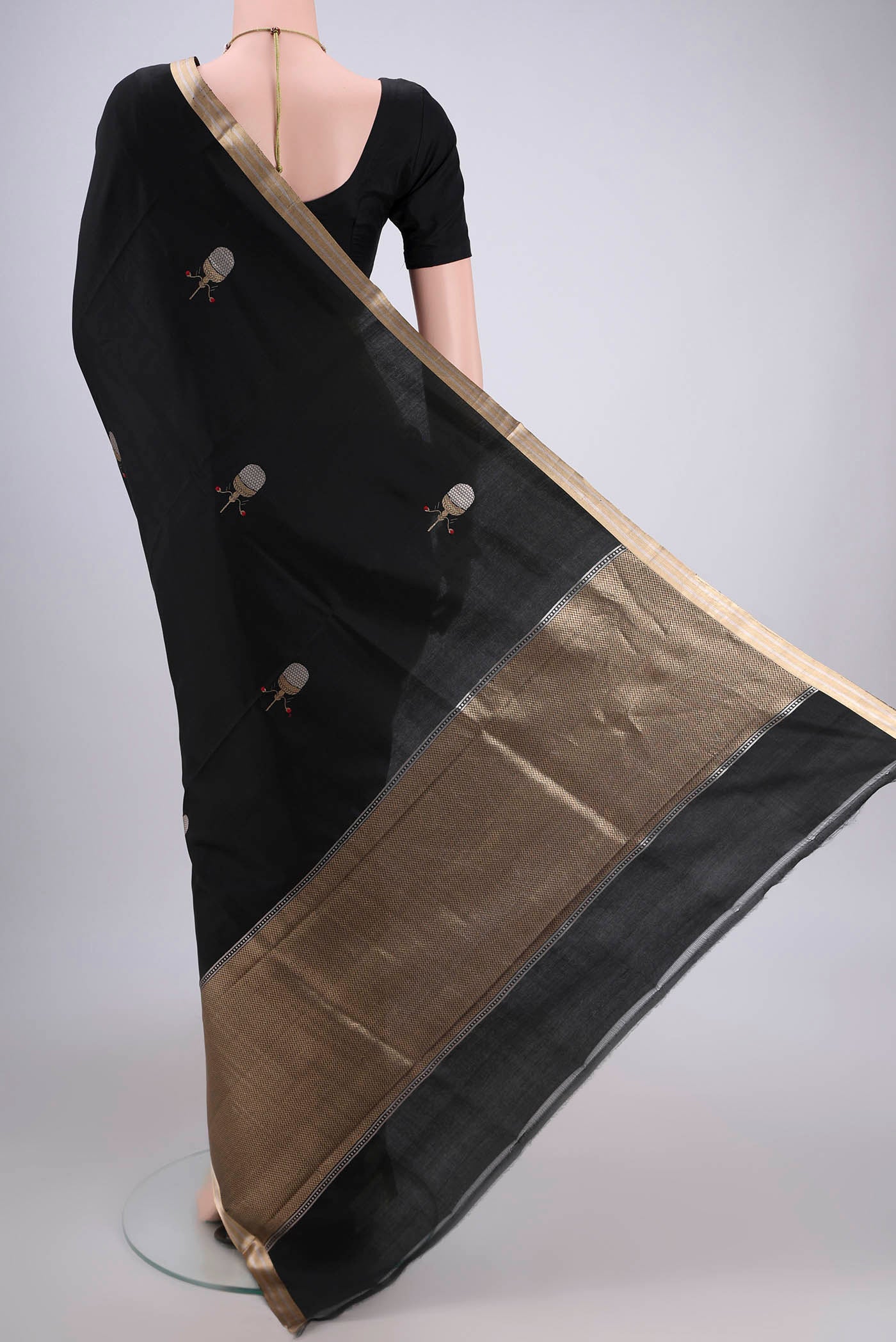 Flat view of Black Banarasi Katan Silk Saree with Zari Butta on the body and Zari Border. 