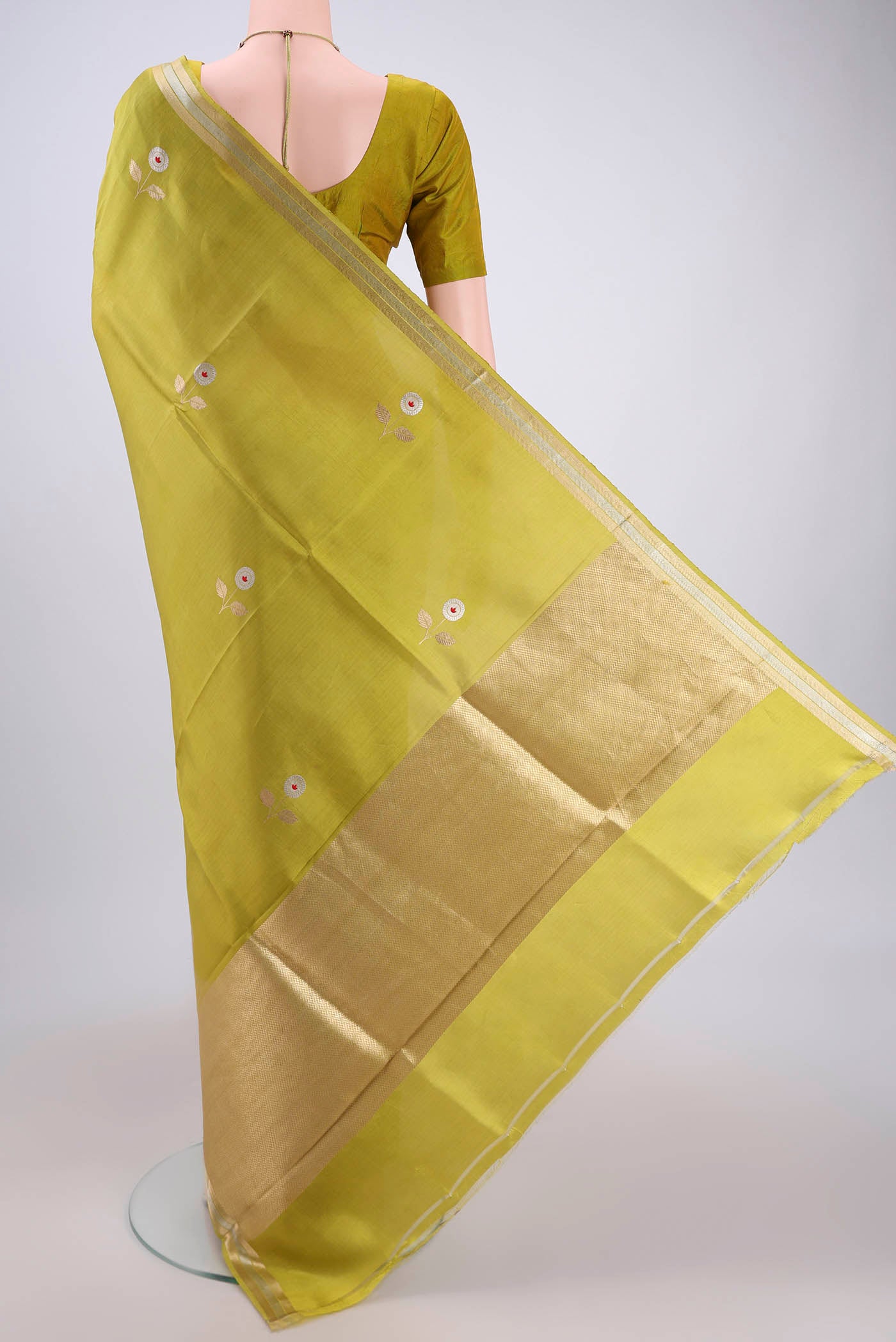 Flat view of Light Green Banarasi Katan Silk Saree with Zari Butta on the body and Zari Border. 