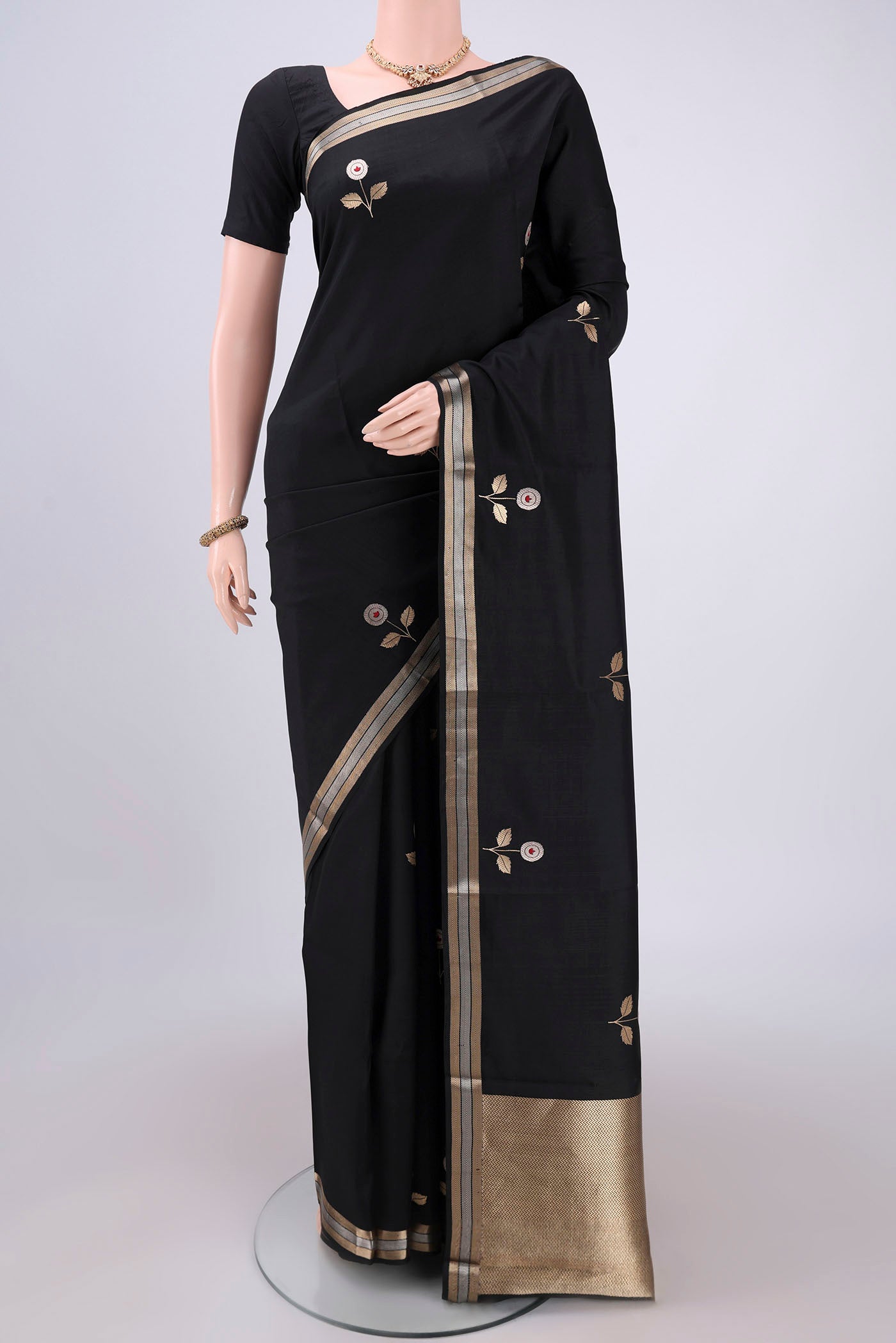 Black Banarasi Katan Silk Saree with Zari And Thread Butta on the body and Zari Border.  displayed on a mannequin