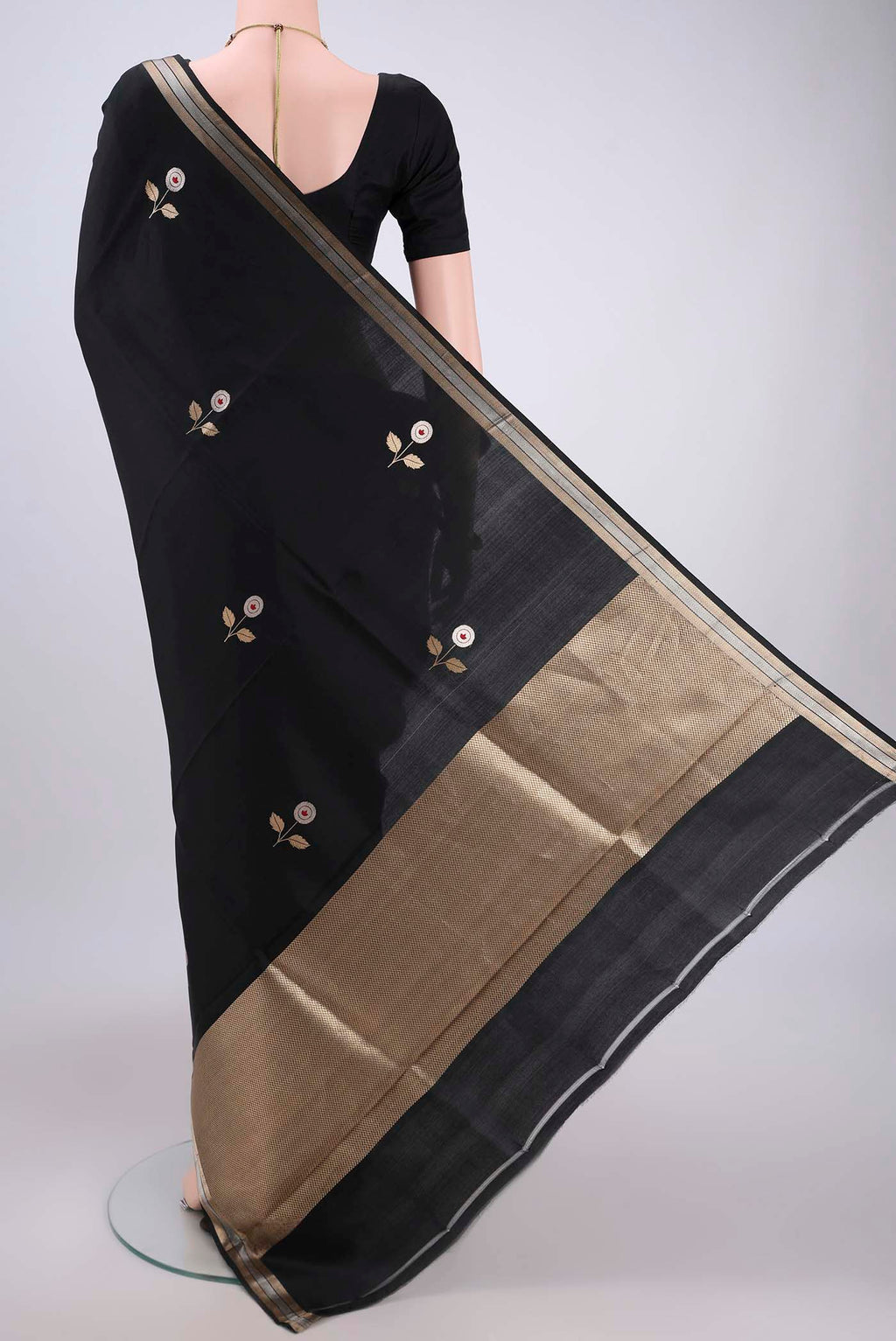 Flat view of Black Banarasi Katan Silk Saree with Zari And Thread Butta on the body and Zari Border. 