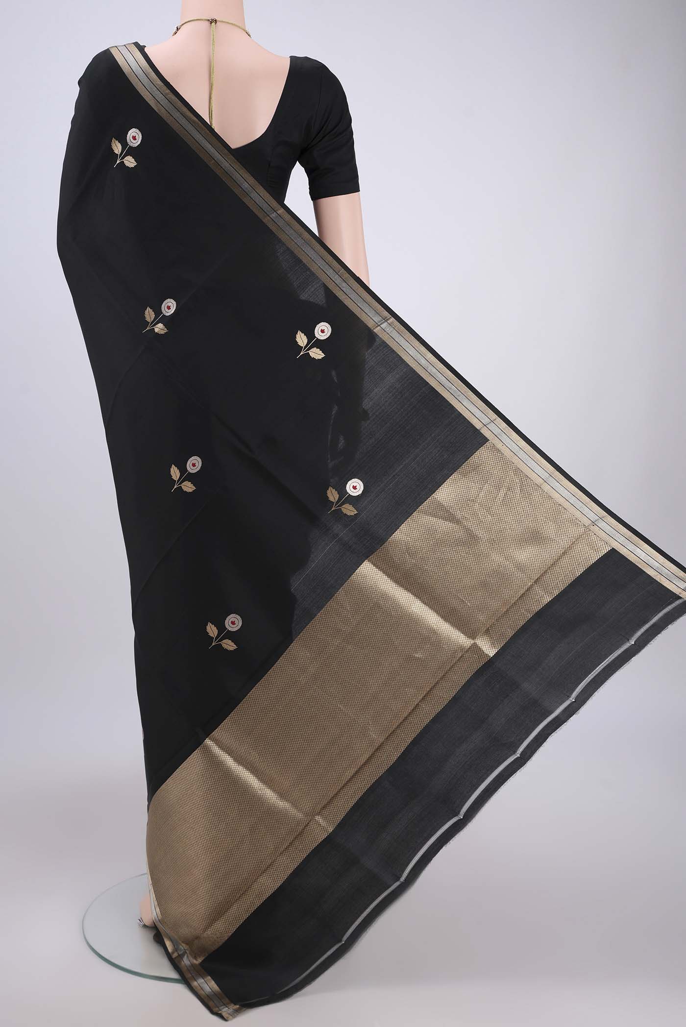Flat view of Black Banarasi Katan Silk Saree with Zari And Thread Butta on the body and Zari Border. 