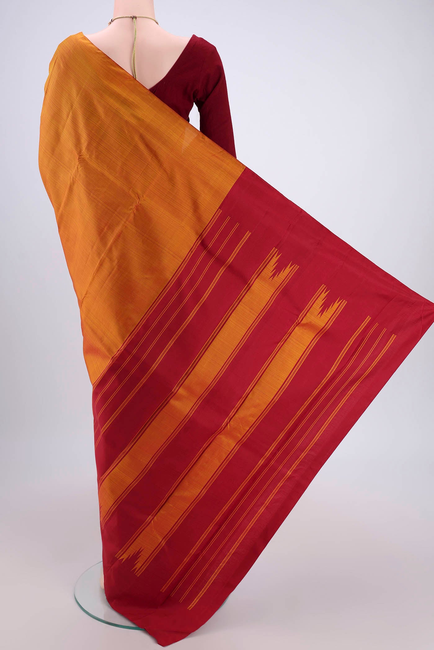 Flat view of Orange Dual Tone Kanchipuram Silk Saree with Plain Body and Temple Border. 