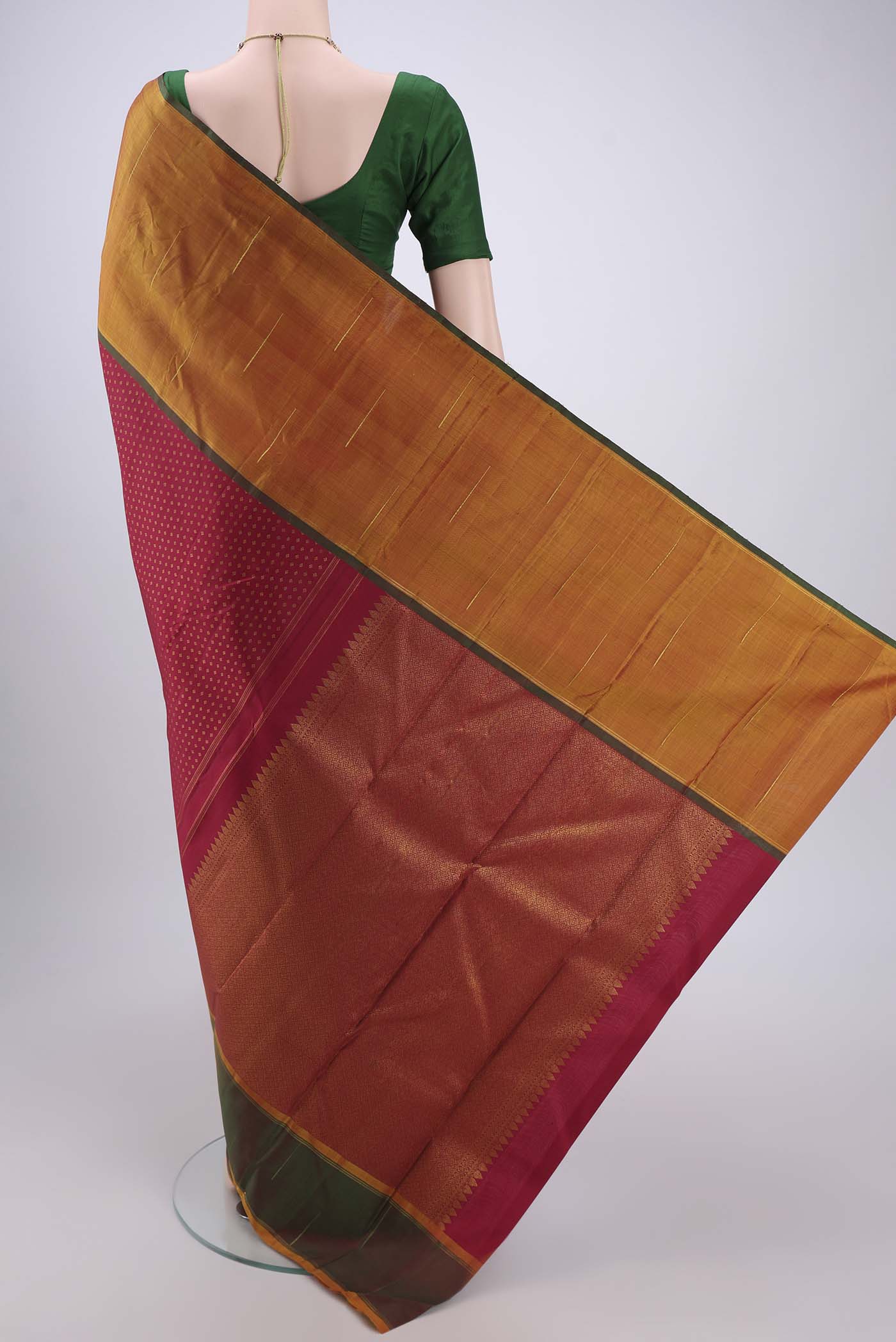 Flat view of Maroon Dual Tone Kanjivaram Silk Saree with Zari Butta on the body and Ganga Jamuna Border. 