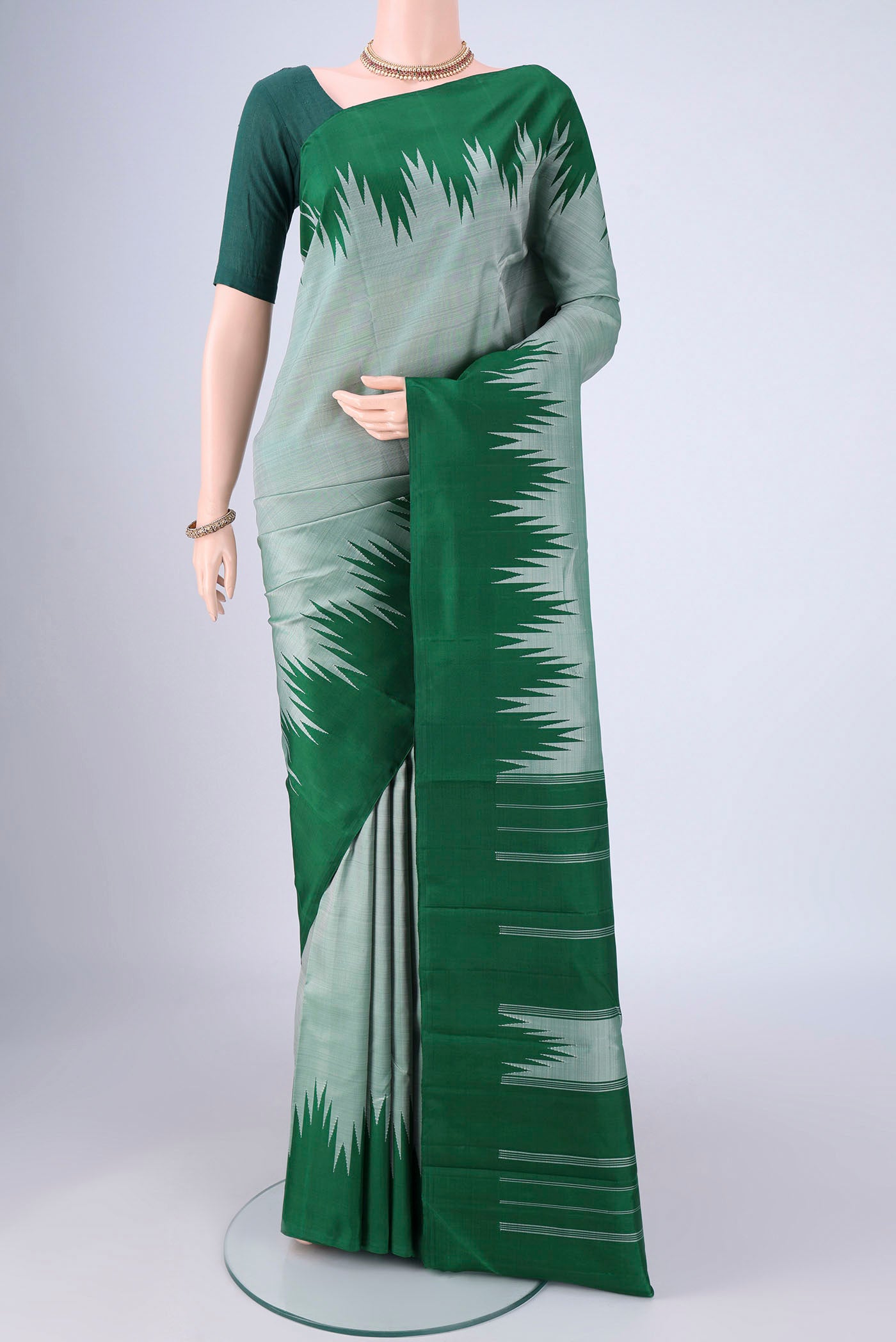 Grey Kanchipuram Silk Saree with Plain Body and Temple Border.  displayed on a mannequin
