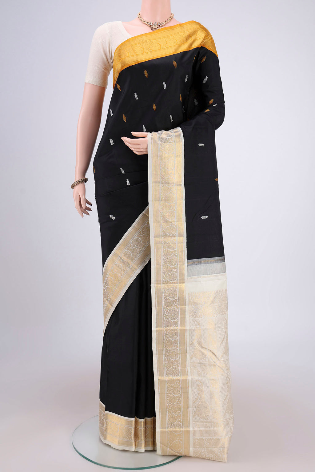Black Dual Tone Kanjivaram Silk Saree with Plain Body and Ganga Jamuna Border.  displayed on a mannequin