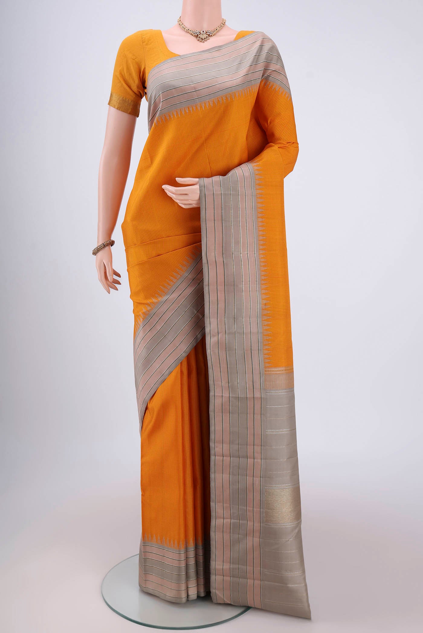 Yellow Dual Tone Kanjivaram Silk Saree with Checked design on the body and Zari Border.  displayed on a mannequin