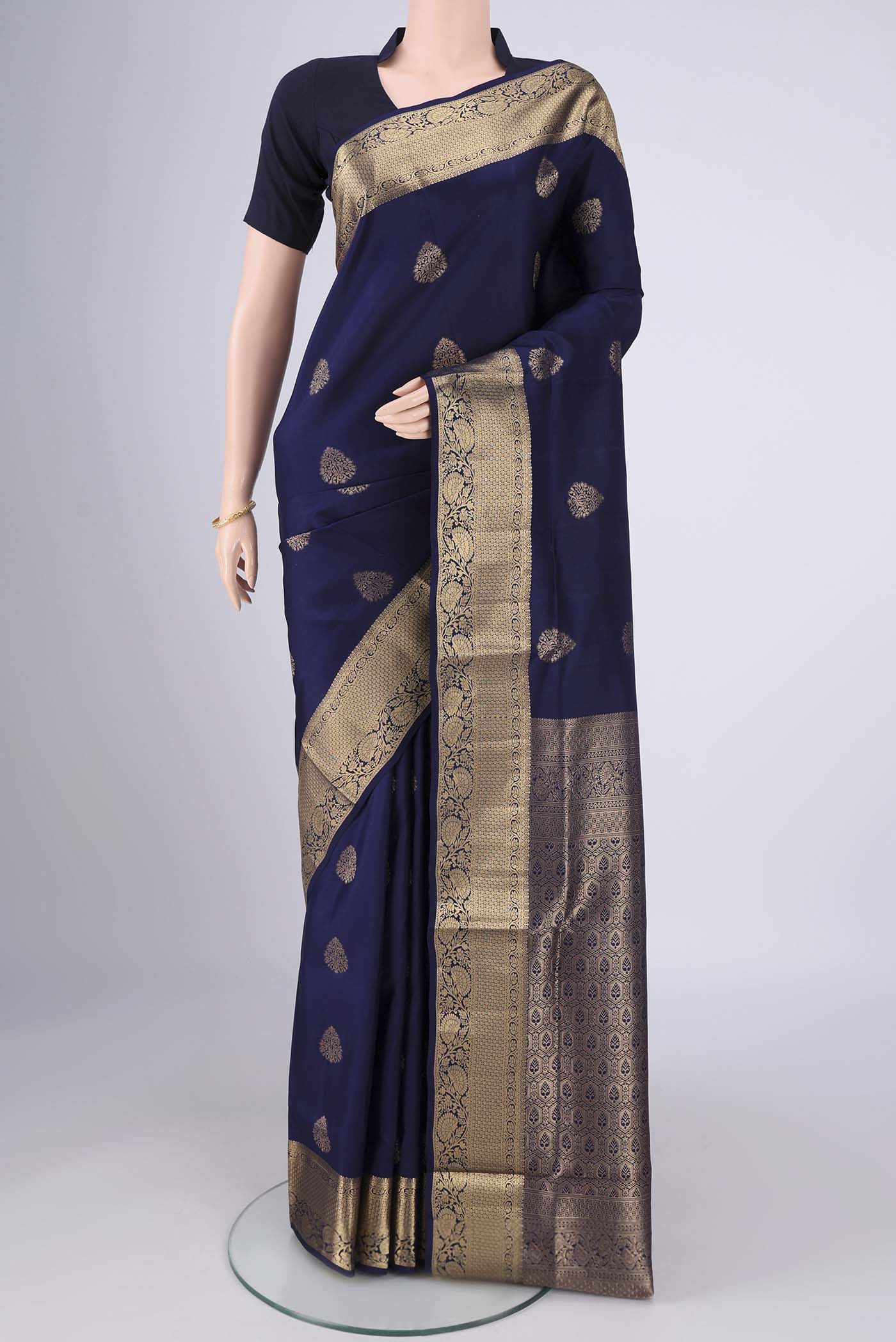 Navy Blue Soft Silk Saree with Zari Butta on the body and Zari Border.  displayed on a mannequin