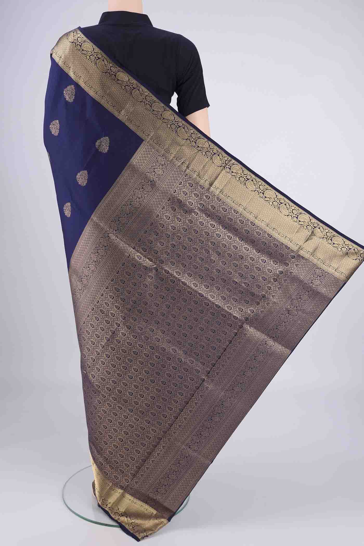 Flat view of Navy Blue Soft Silk Saree with Zari Butta on the body and Zari Border. 