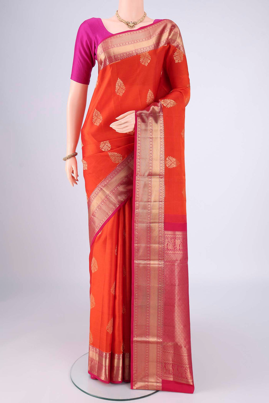 Orange Dual Tone Soft Silk Saree with Zari Brocade on the body and Zari Border.  displayed on a mannequin