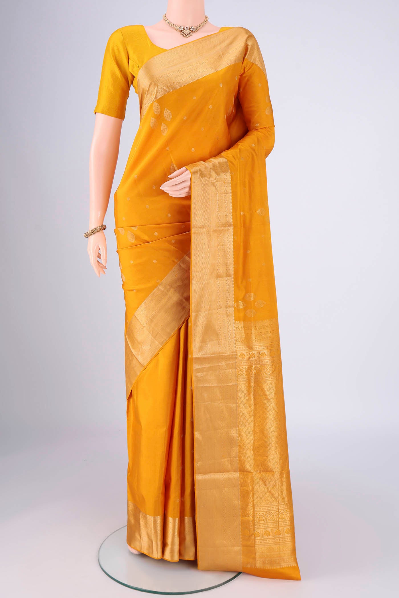 Mustard Dual Tone Soft Silk Saree with Zari Brocade on the body and Zari Border.  displayed on a mannequin