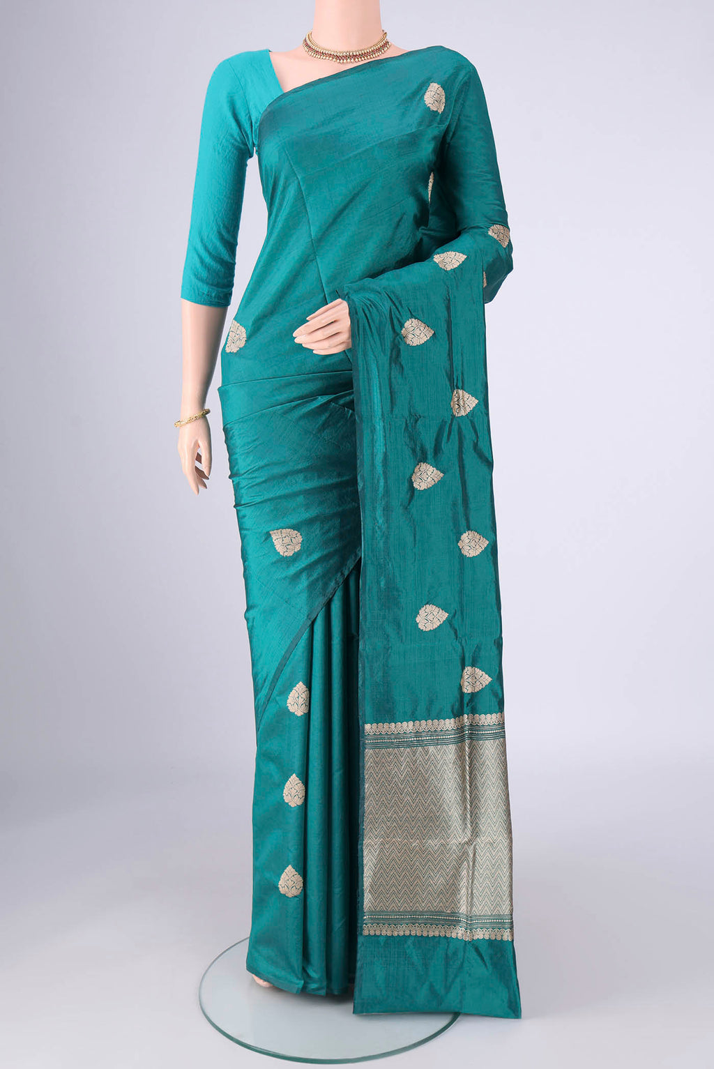 Teal Dual Tone Banarasi Silk Saree with Zari Butta on the body and Without Border.  displayed on a mannequin