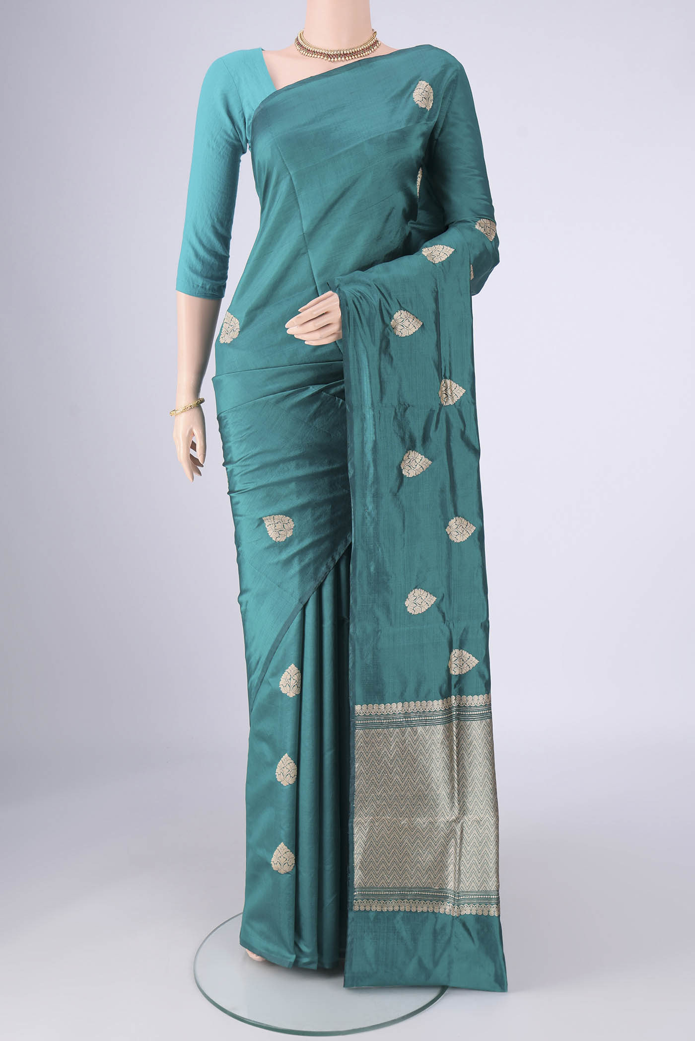 Teal Dual Tone Banarasi Silk Saree with Zari Butta on the body and Without Border.  displayed on a mannequin