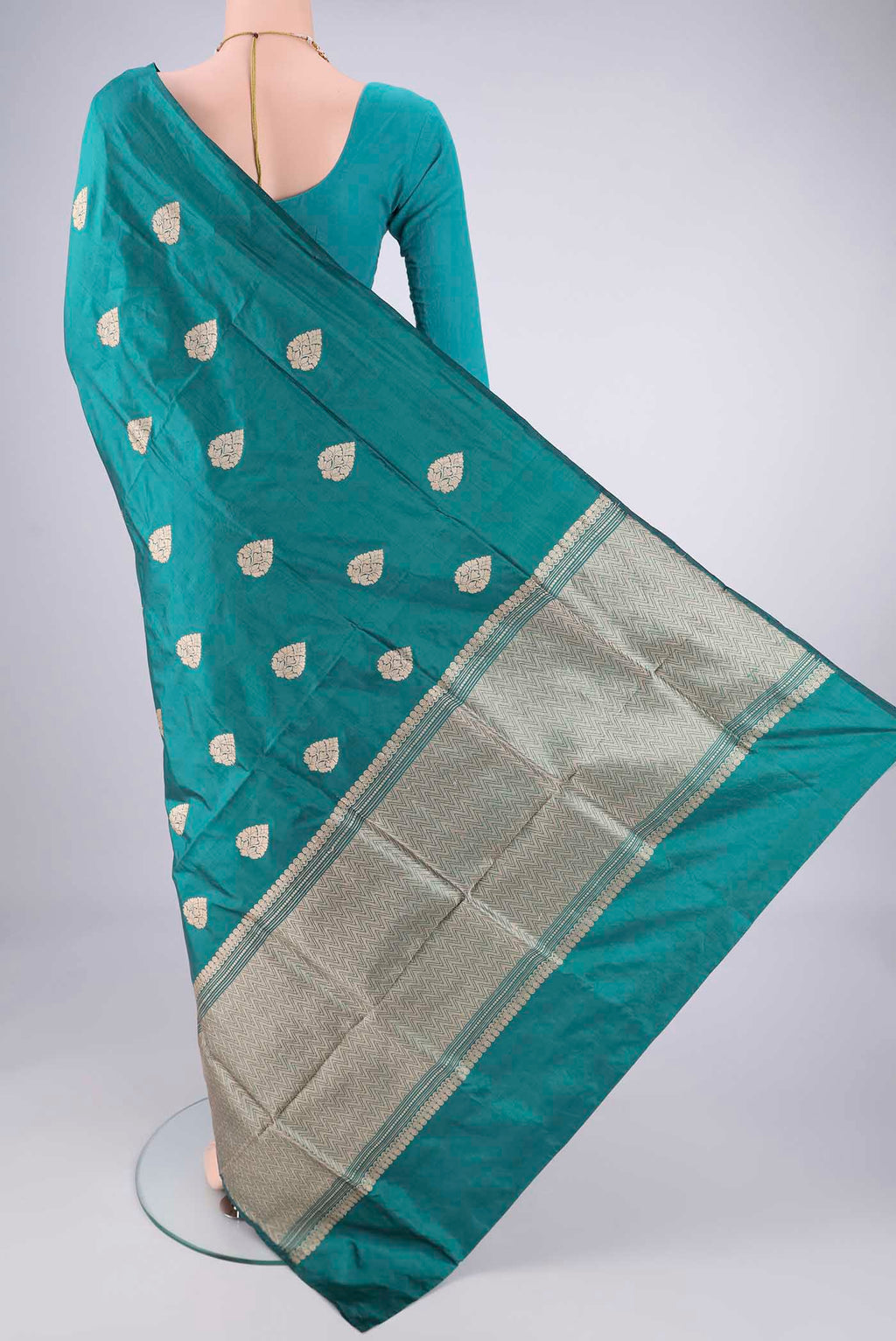 Flat view of Teal Dual Tone Banarasi Silk Saree with Zari Butta on the body and Without Border. 