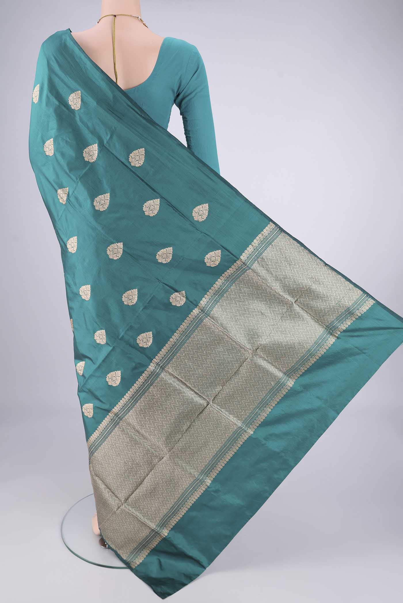 Flat view of Teal Dual Tone Banarasi Silk Saree with Zari Butta on the body and Without Border. 