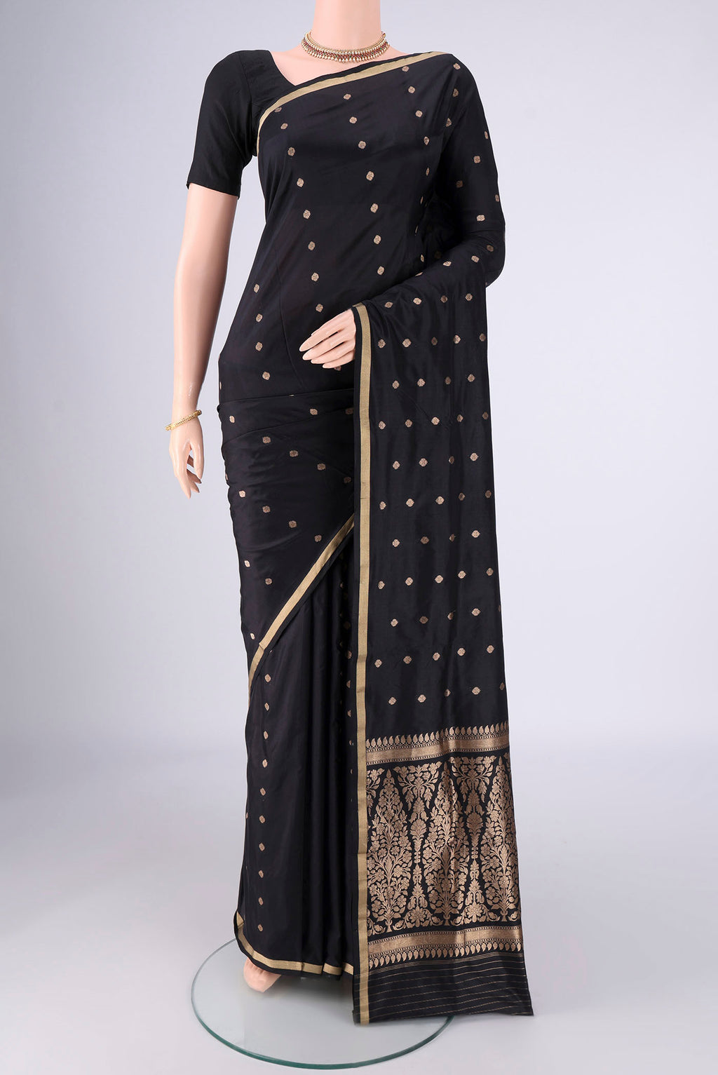 Black Banarasi Silk Saree with Zari Butta on the body and Thin Zari Line.  displayed on a mannequin