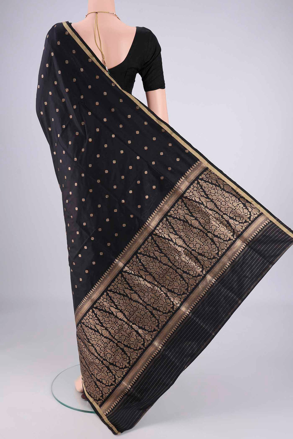 Flat view of Black Banarasi Silk Saree with Zari Butta on the body and Thin Zari Line. 