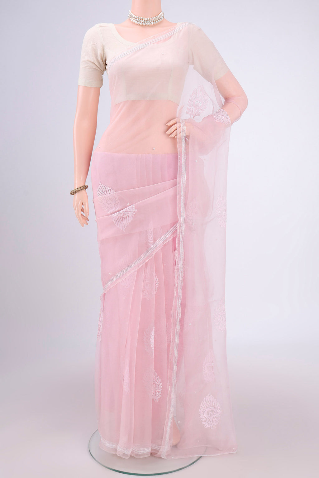 Rose pink Organza Silk Saree with Embroidery on the body and Thin Zari Line.  displayed on a mannequin