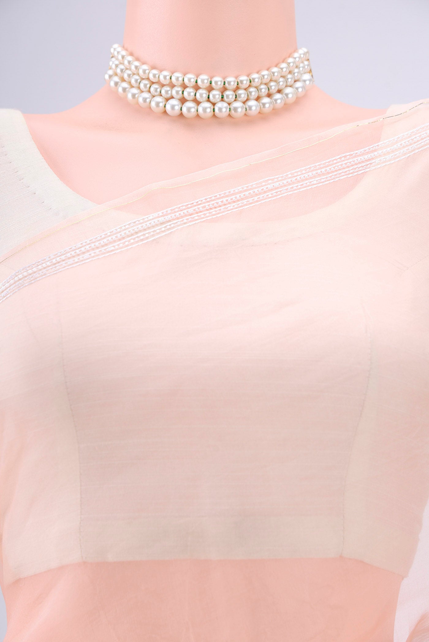 Border image of Peach Organza Silk Saree with Embroidery on the body and Zari Border. 