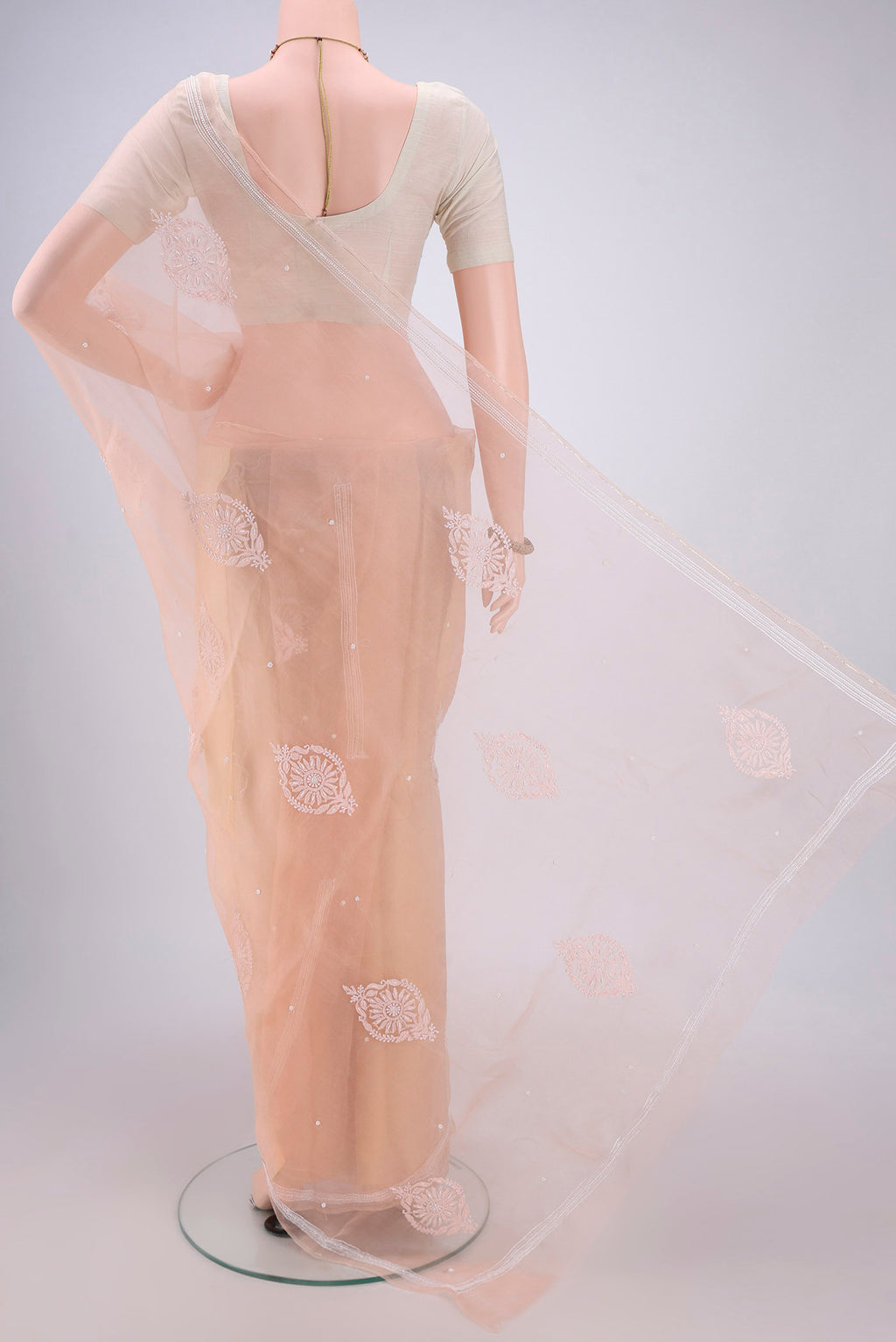 Flat view of Peach Organza Silk Saree with Embroidery on the body and Zari Border. 