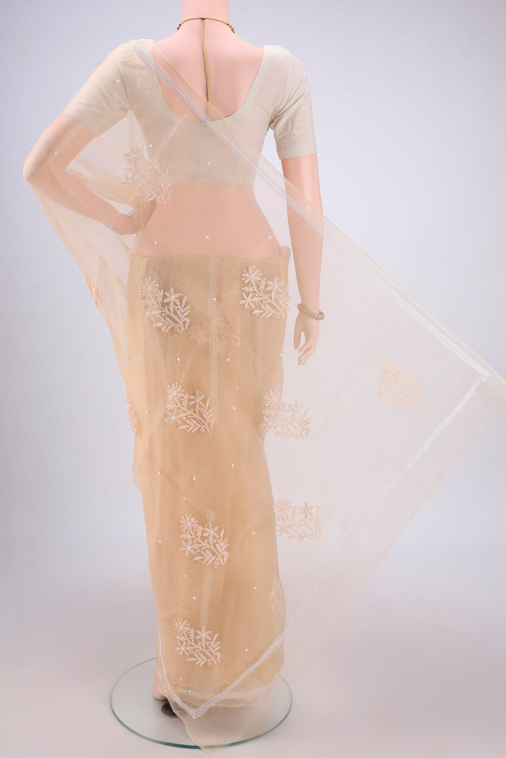 Flat view of Beige Organza Silk Saree with Embroidery on the body and Thin Zari Line. 