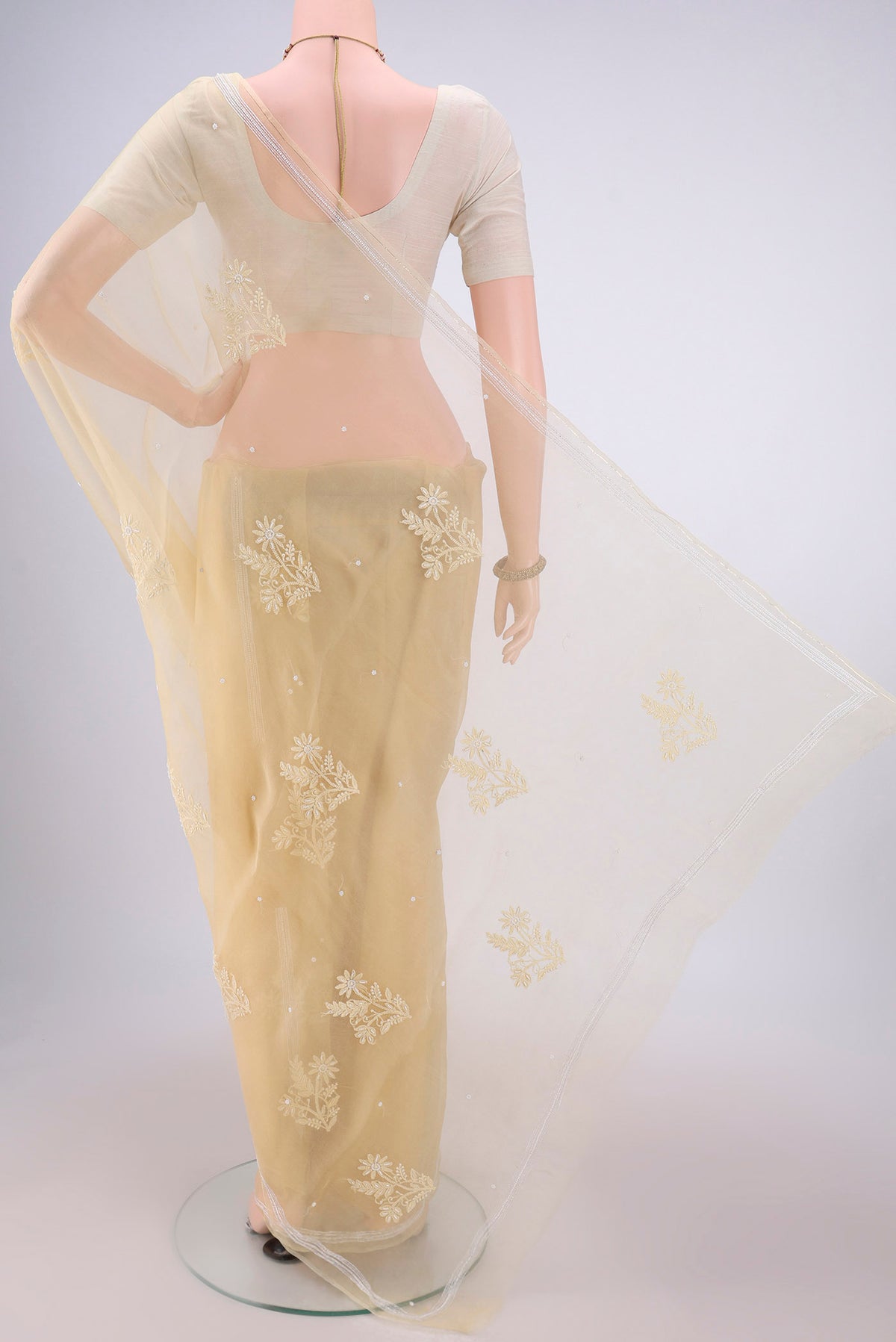 Flat view of Lemon Yellow Organza Silk Saree with Embroidery on the body and Zari Border. 