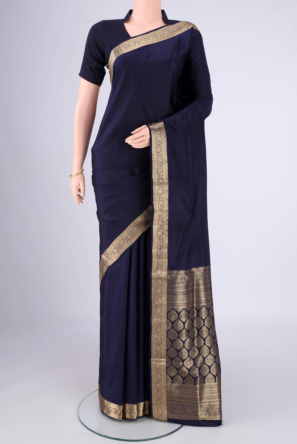 Navy Blue Soft Silk Saree with Plain Body and Zari Border.  displayed on a mannequin