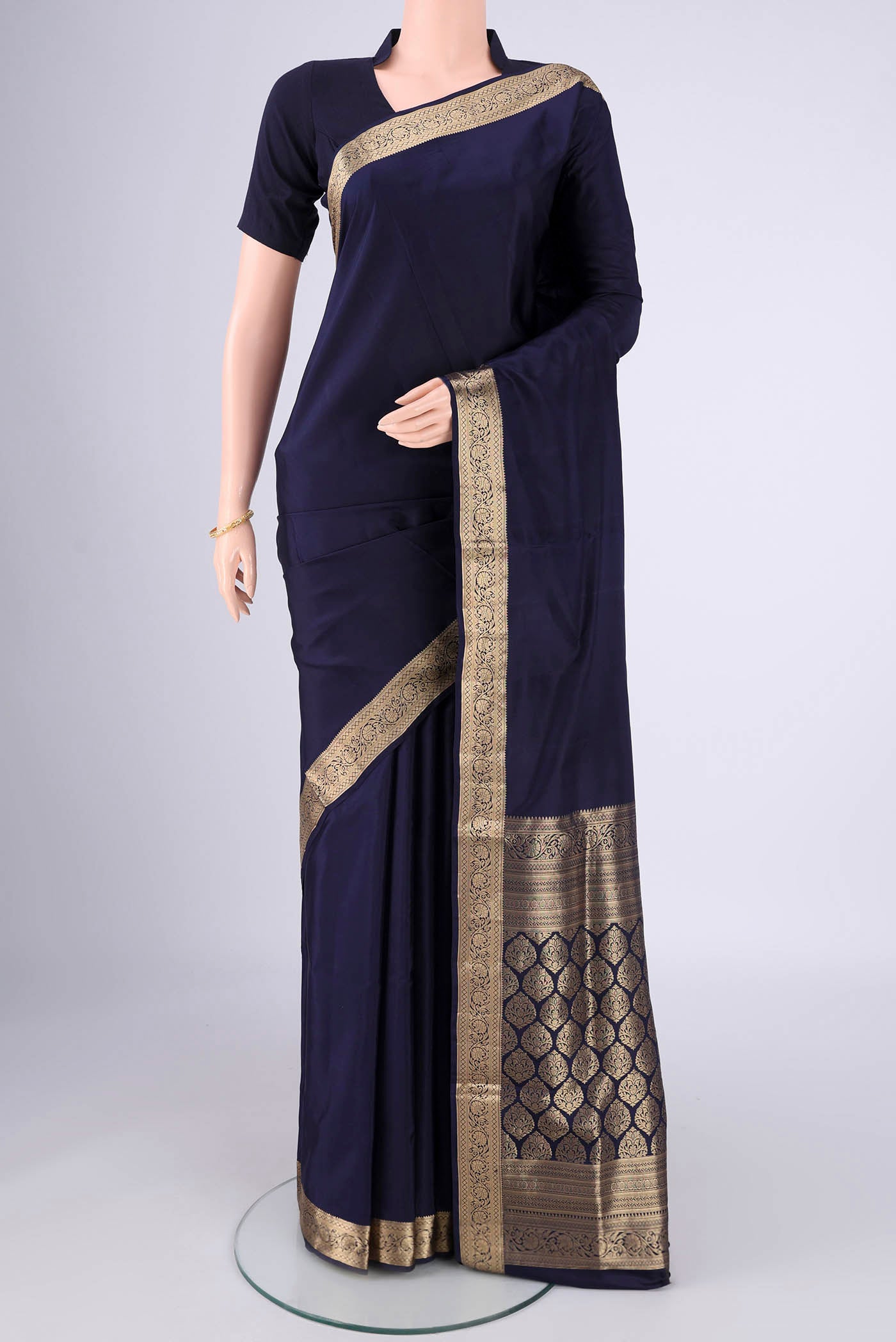 Navy Blue Soft Silk Saree with Plain Body and Zari Border.  displayed on a mannequin