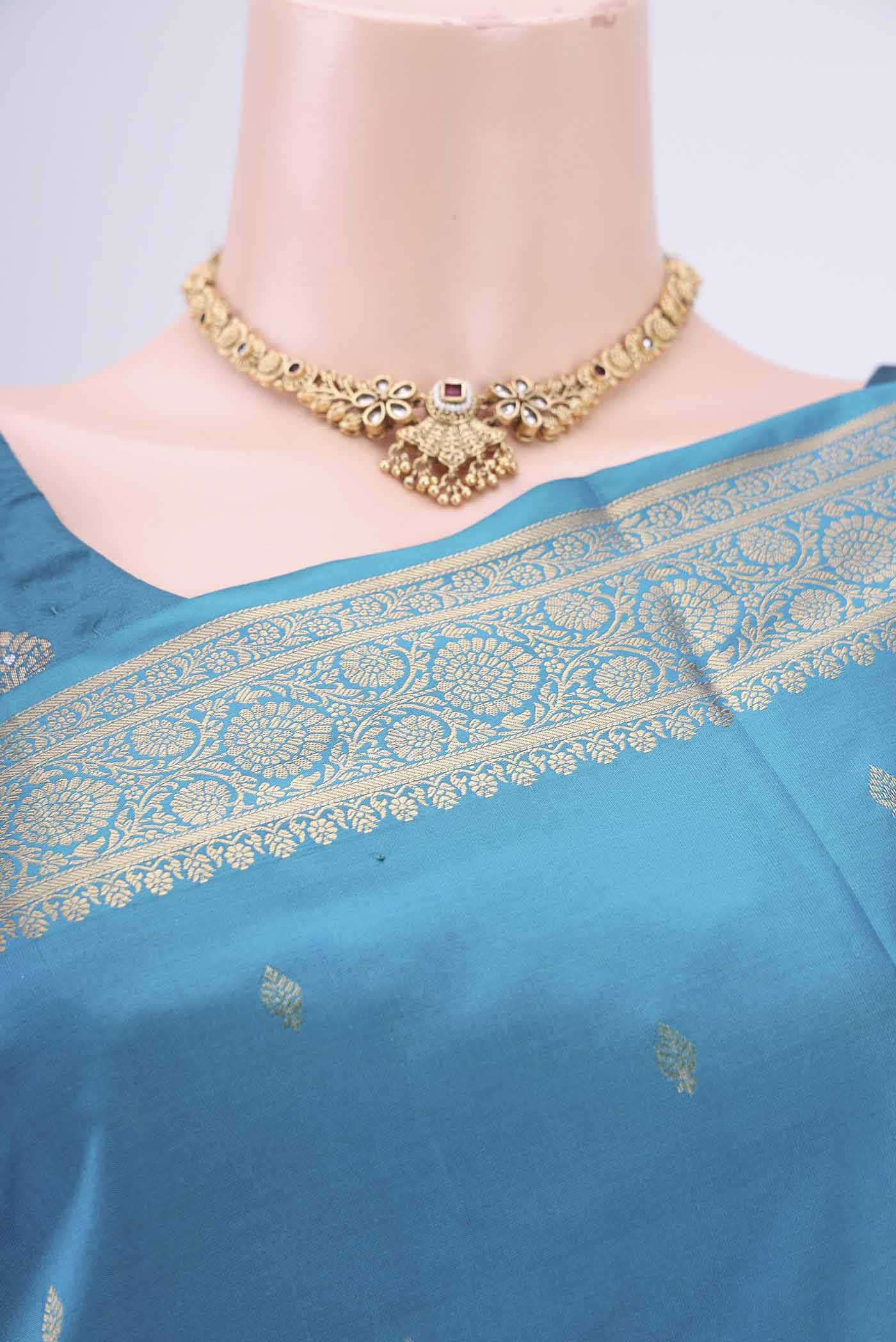 Border image of Turquoise Soft Silk Saree with Zari Butta on the body and Zari Border. 
