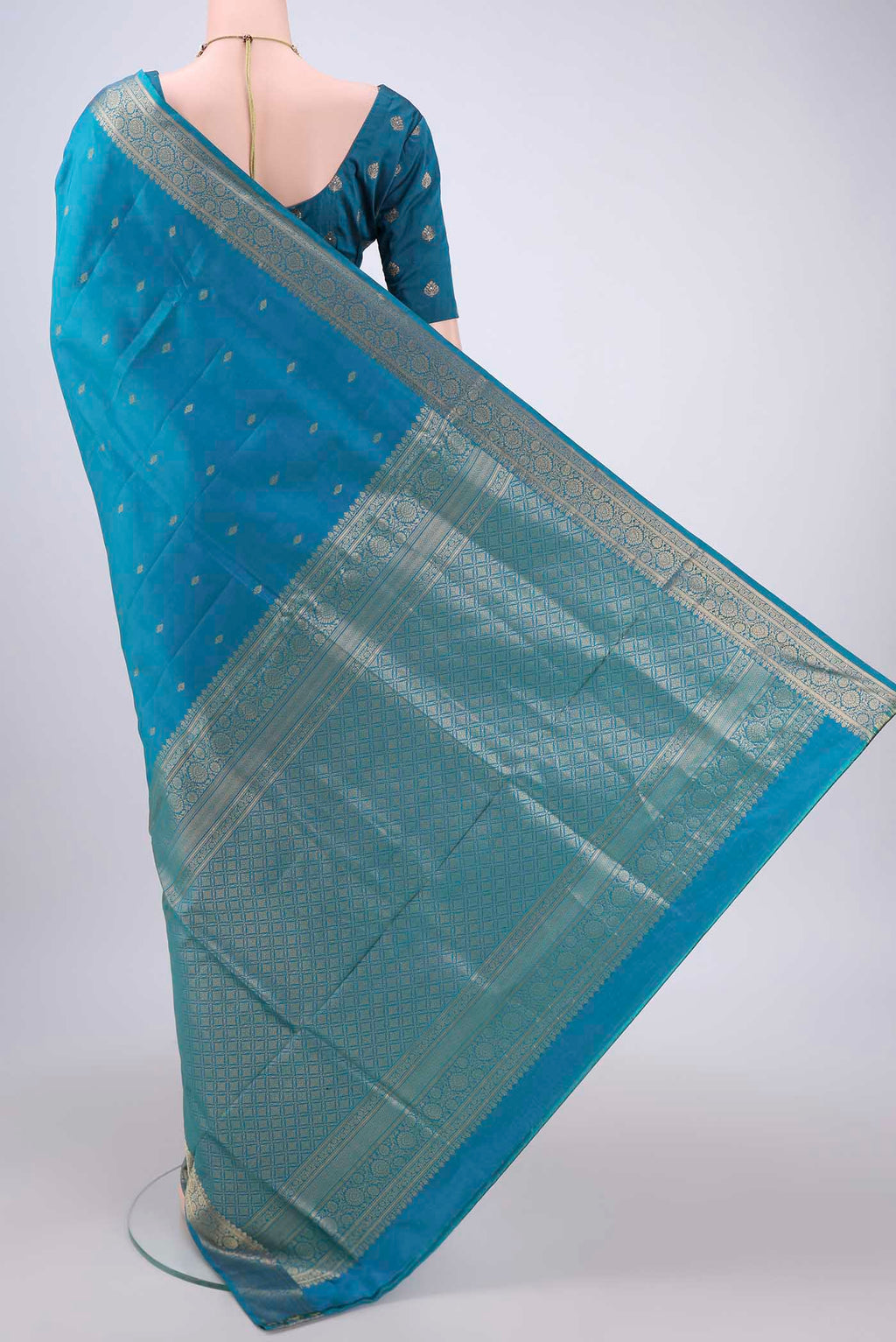 Flat view of Turquoise Soft Silk Saree with Zari Butta on the body and Zari Border. 