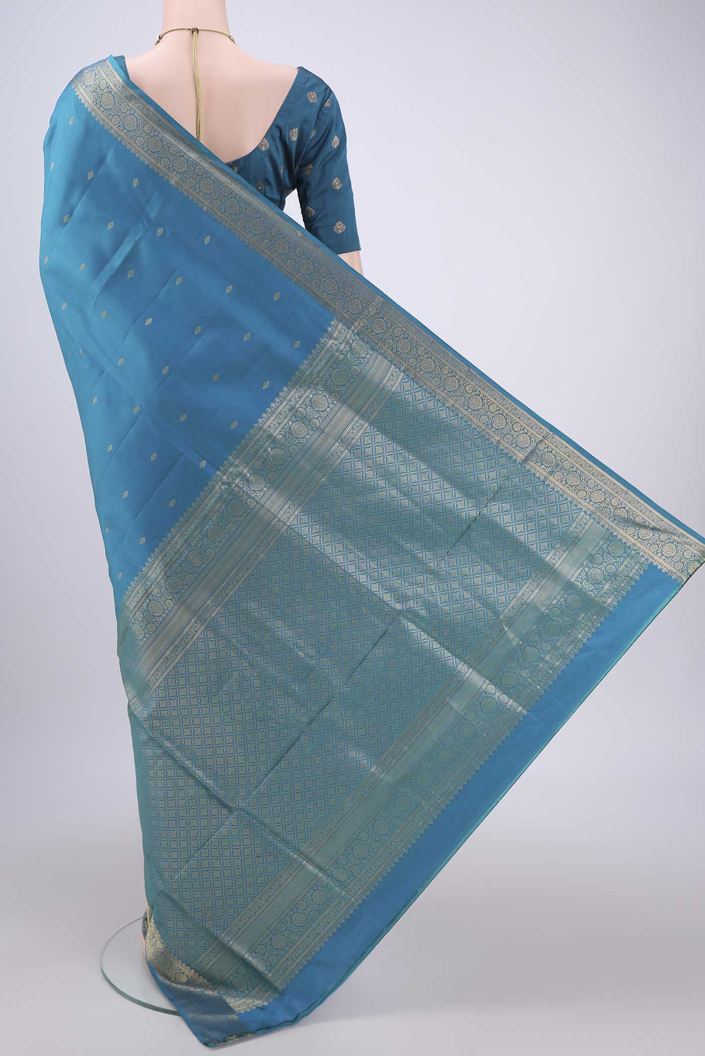 Flat view of Turquoise Soft Silk Saree with Zari Butta on the body and Zari Border. 
