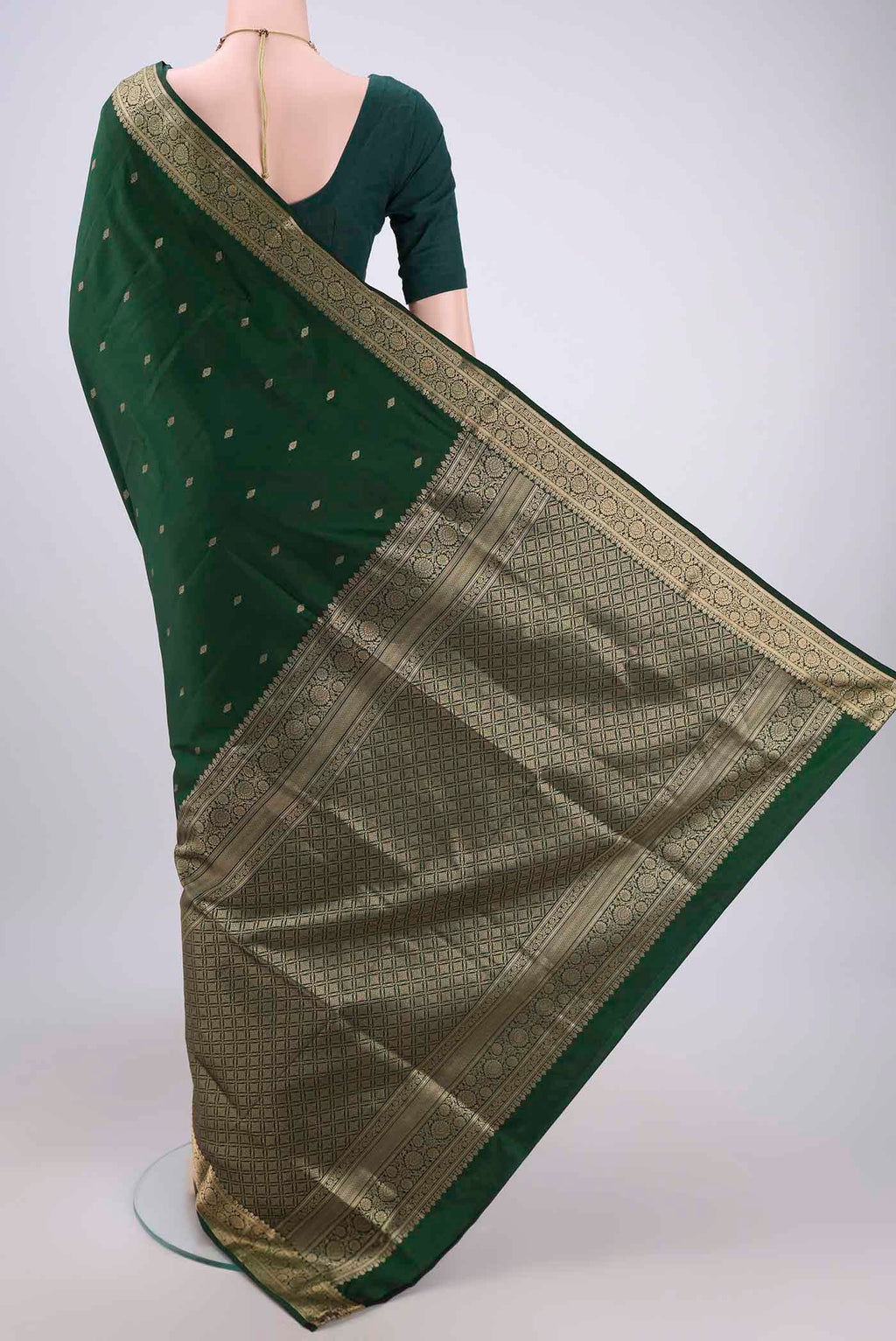 Flat view of Bottle Green Soft Silk Saree with Zari Butta on the body and Zari Border. 