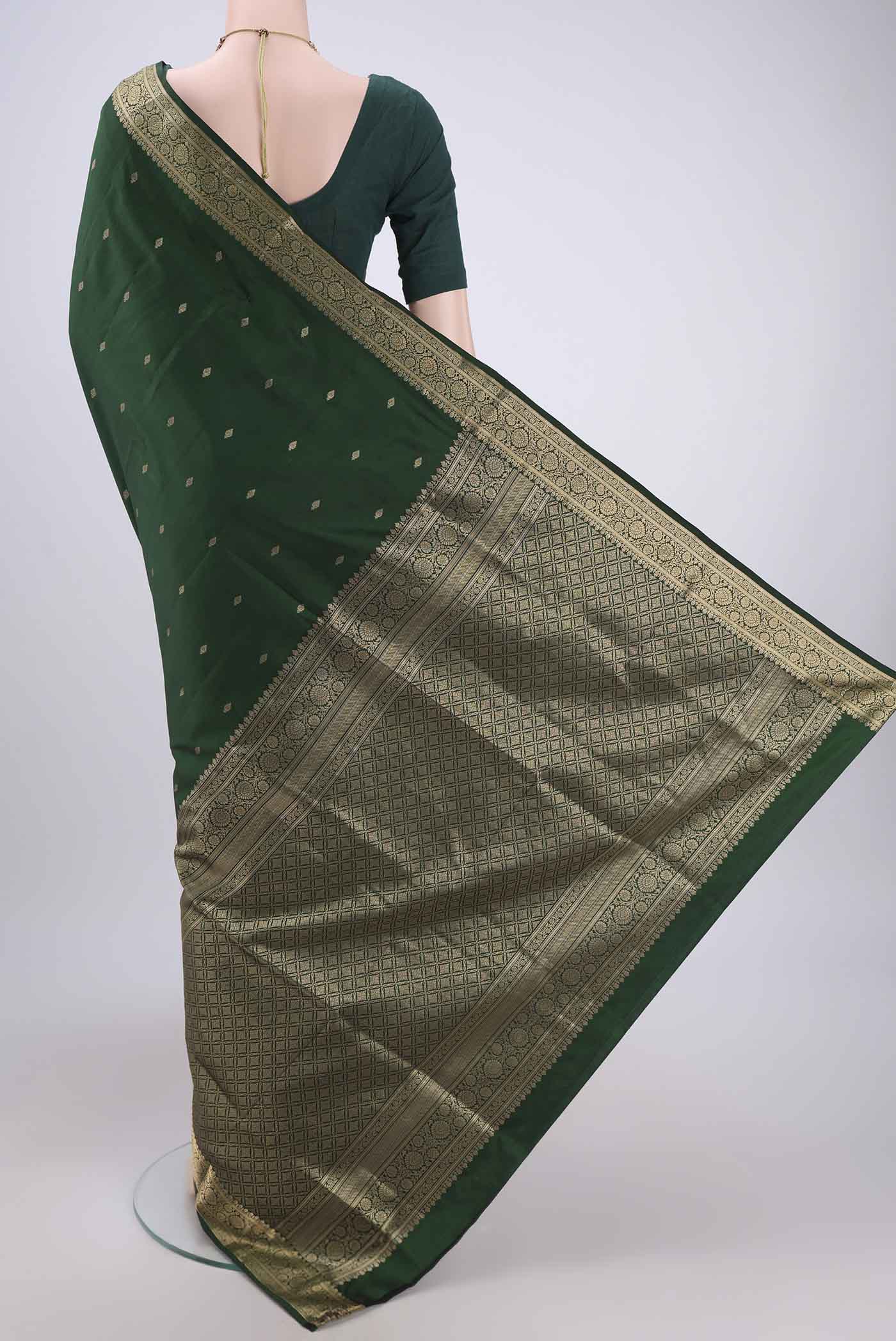 Flat view of Bottle Green Soft Silk Saree with Zari Butta on the body and Zari Border. 