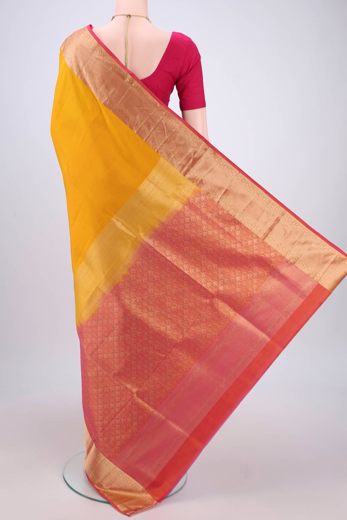Flat view of Yellow Soft Silk Saree with Zari Butta on the body and Zari Border. 