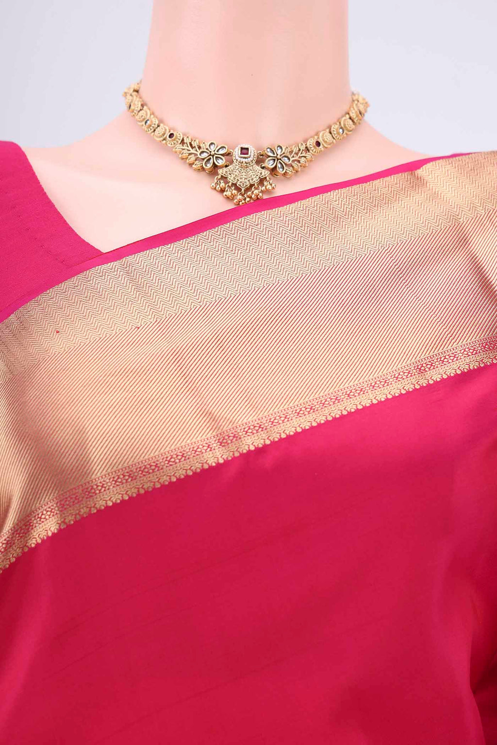 Border image of Rani Pink Soft Silk Saree with Zari Butta on the body and Zari Border. 