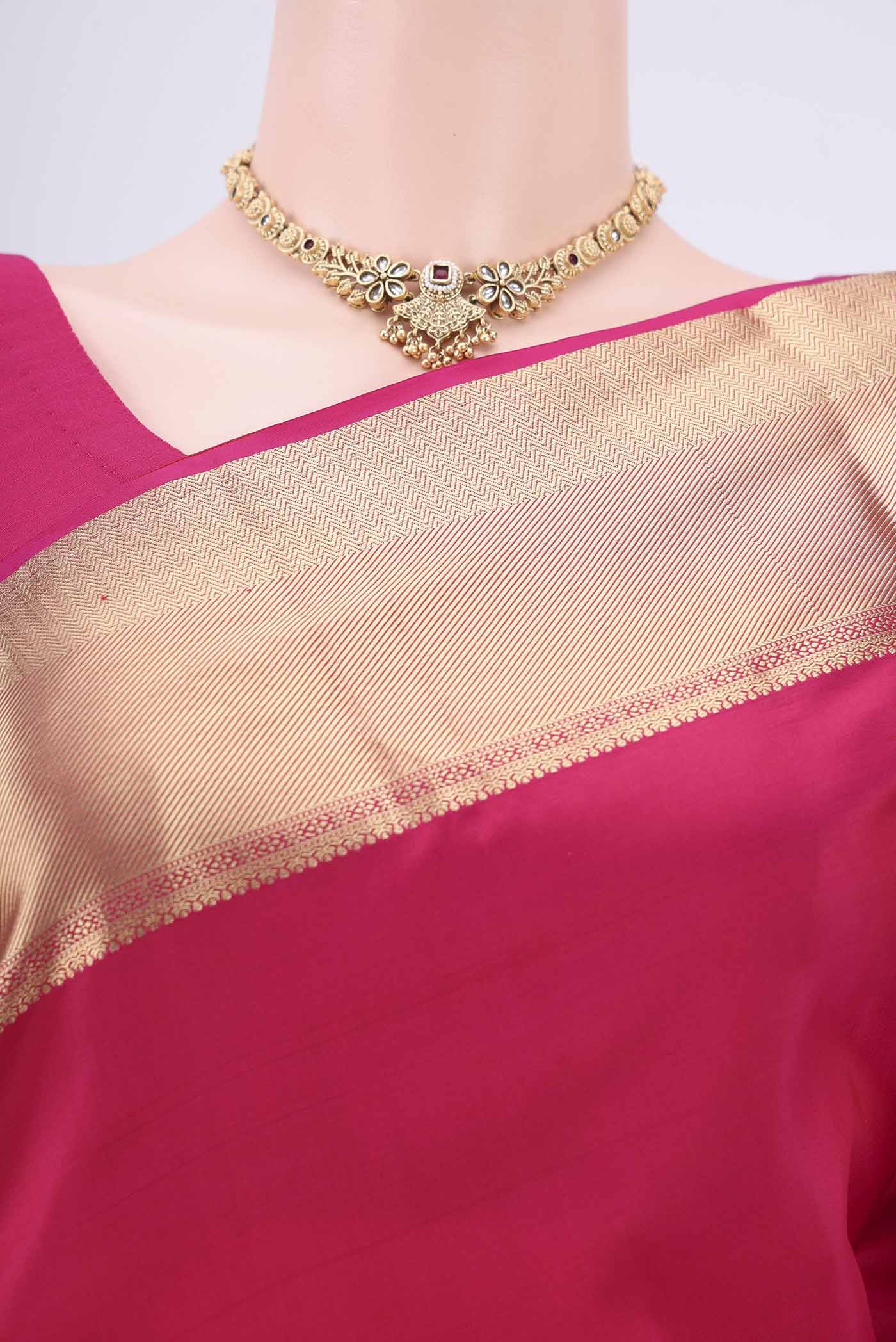 Border image of Rani Pink Soft Silk Saree with Zari Butta on the body and Zari Border. 